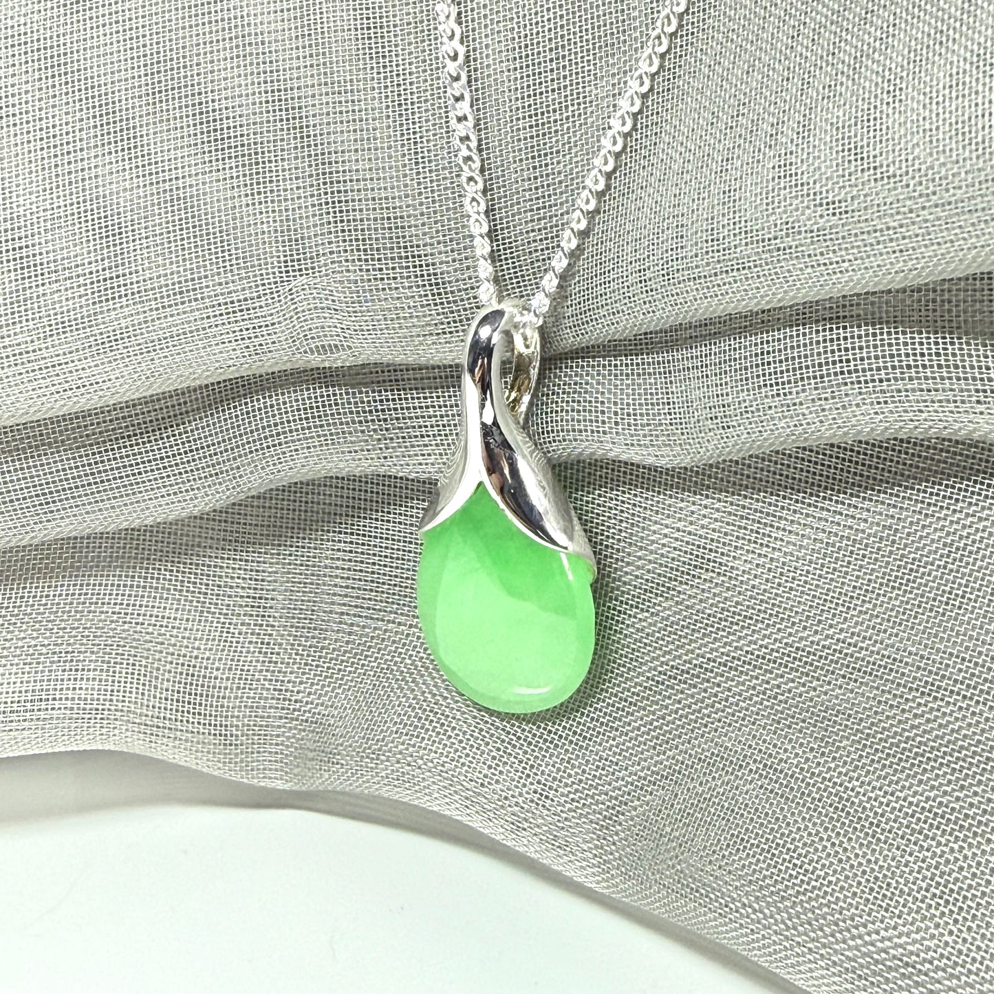 Green jade cushion shaped silver necklace pendant, a stunning design