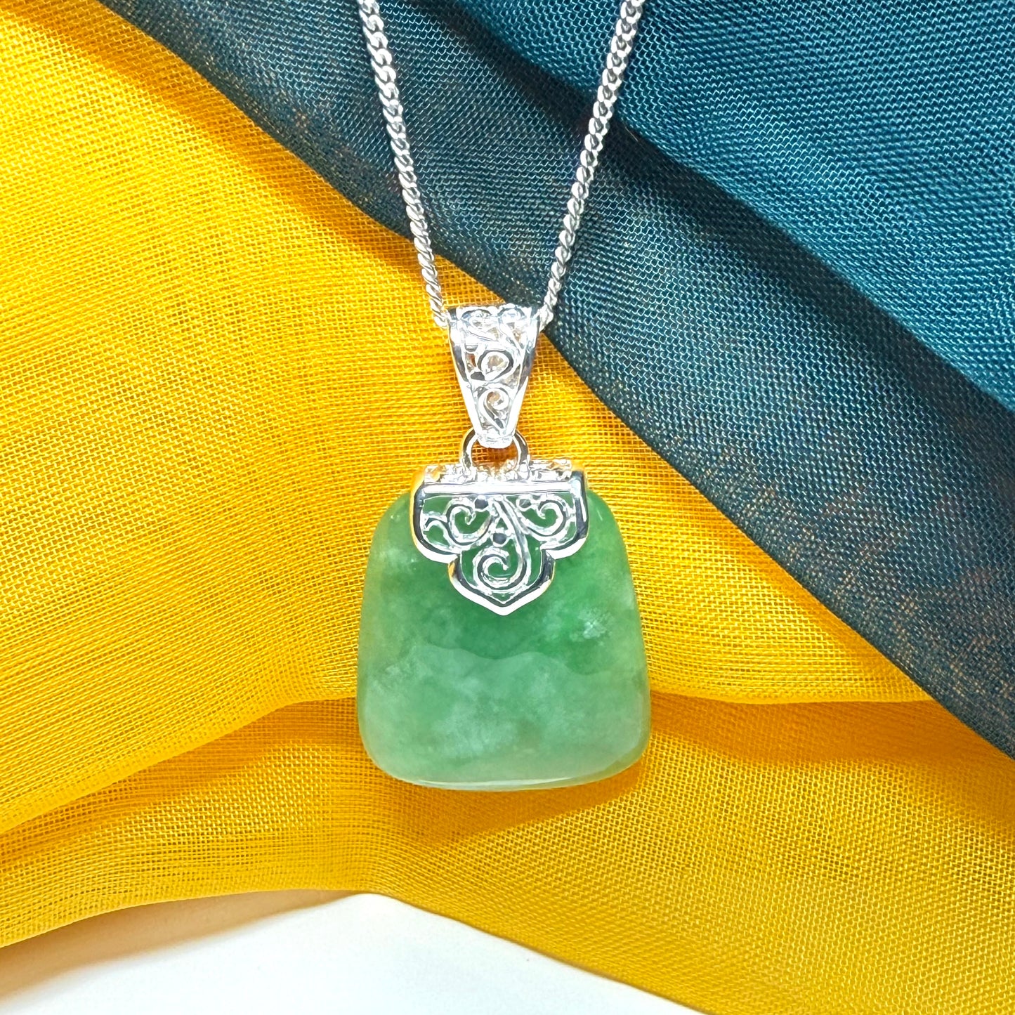 Green real jade necklace with a large shaped and patterned pendant