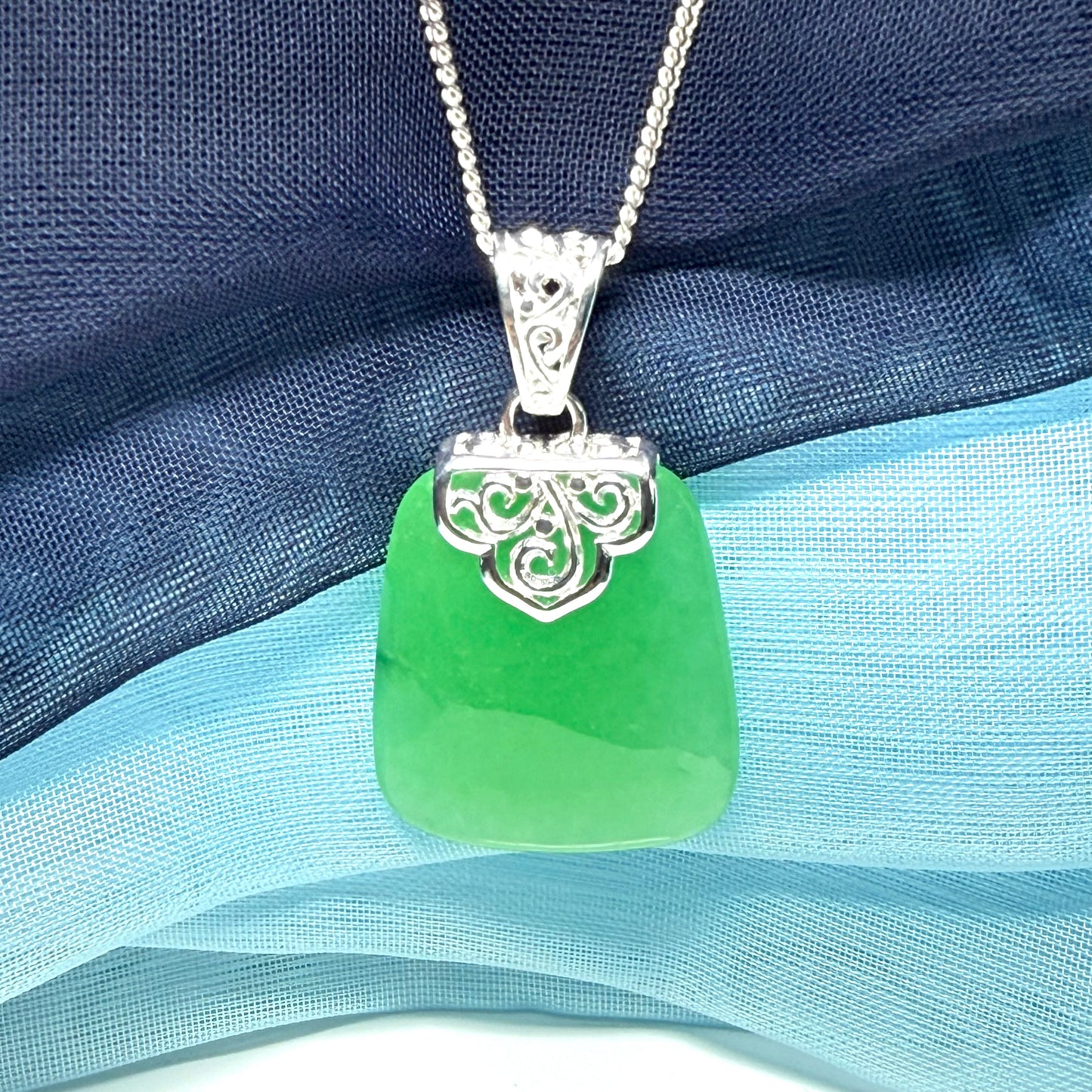Green real jade necklace with a large shaped and patterned pendant with chain