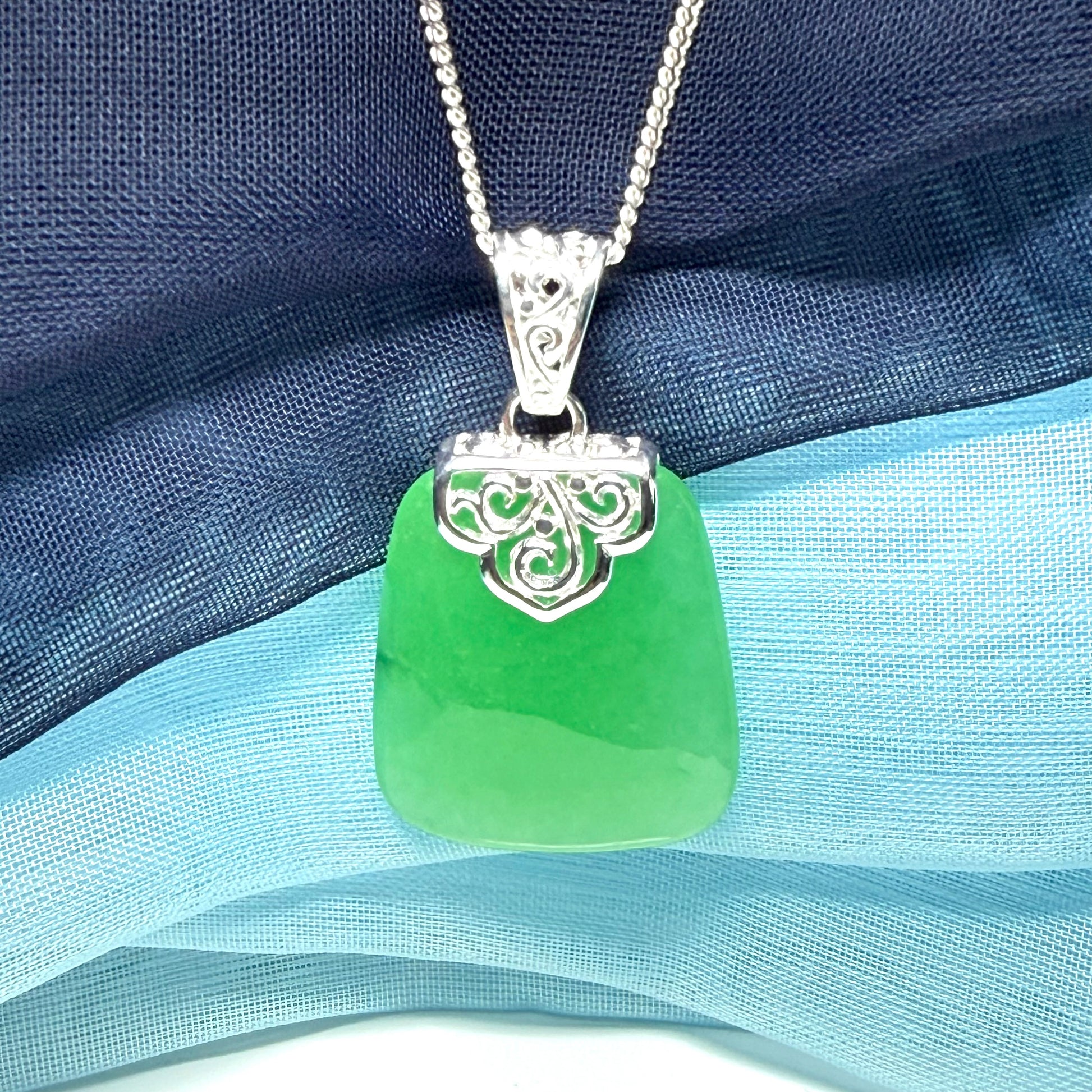 Green real jade necklace with a large shaped and patterned pendant with chain