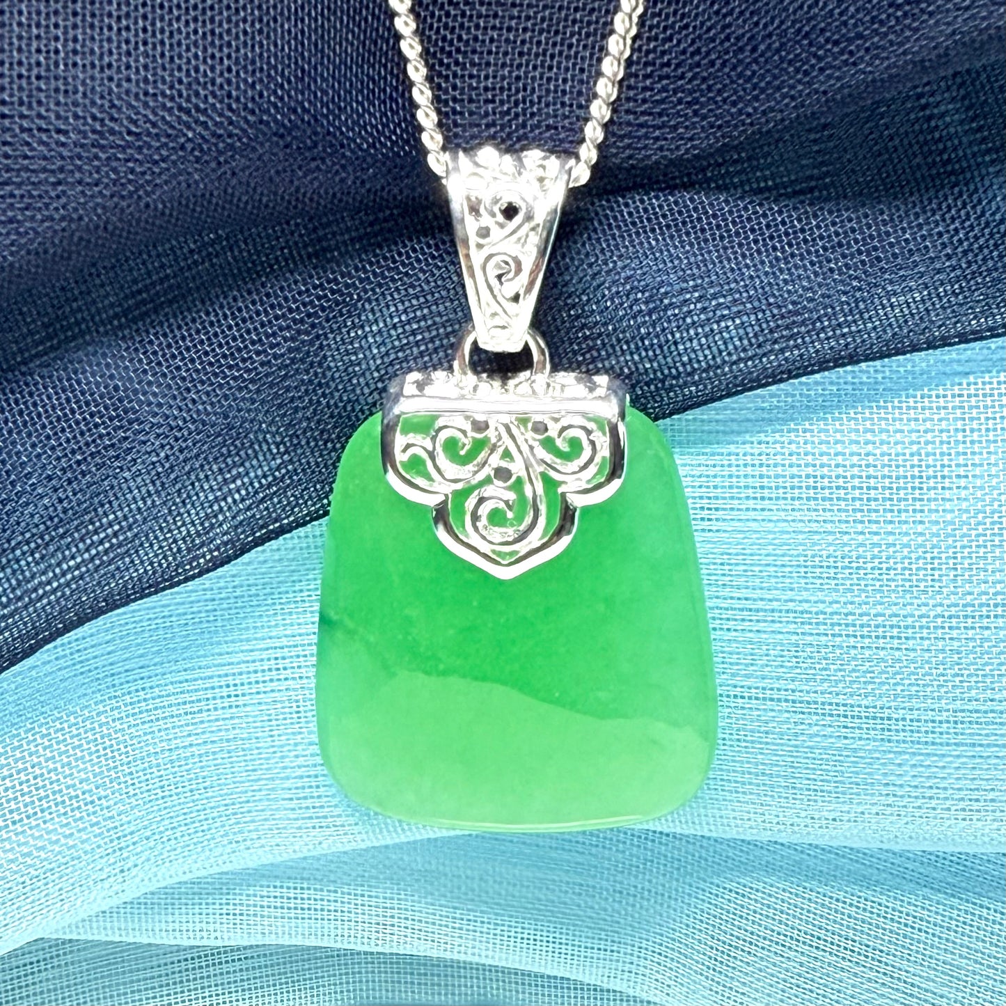 Green real jade necklace with a large shaped and patterned pendant with chain