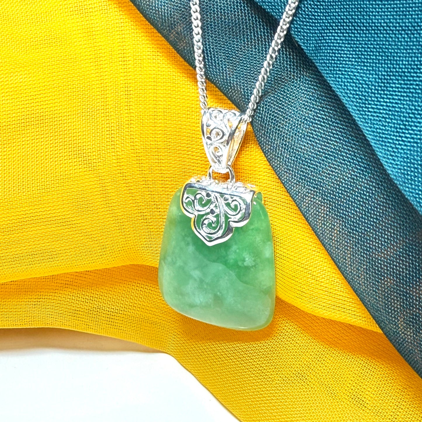 Green real jade necklace with a large shaped and patterned pendant