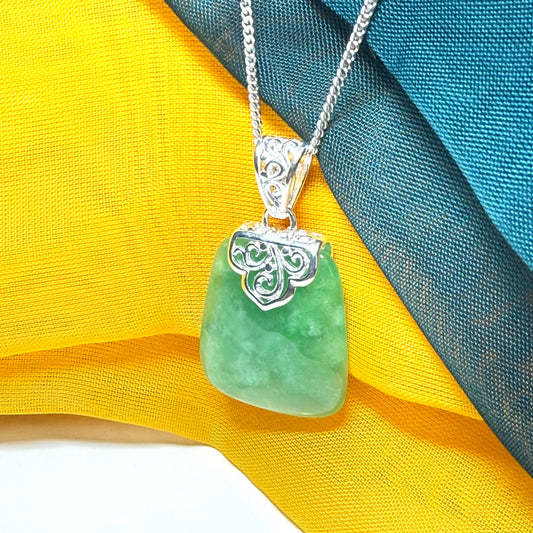 Green real jade necklace with a large shaped and patterned pendant
