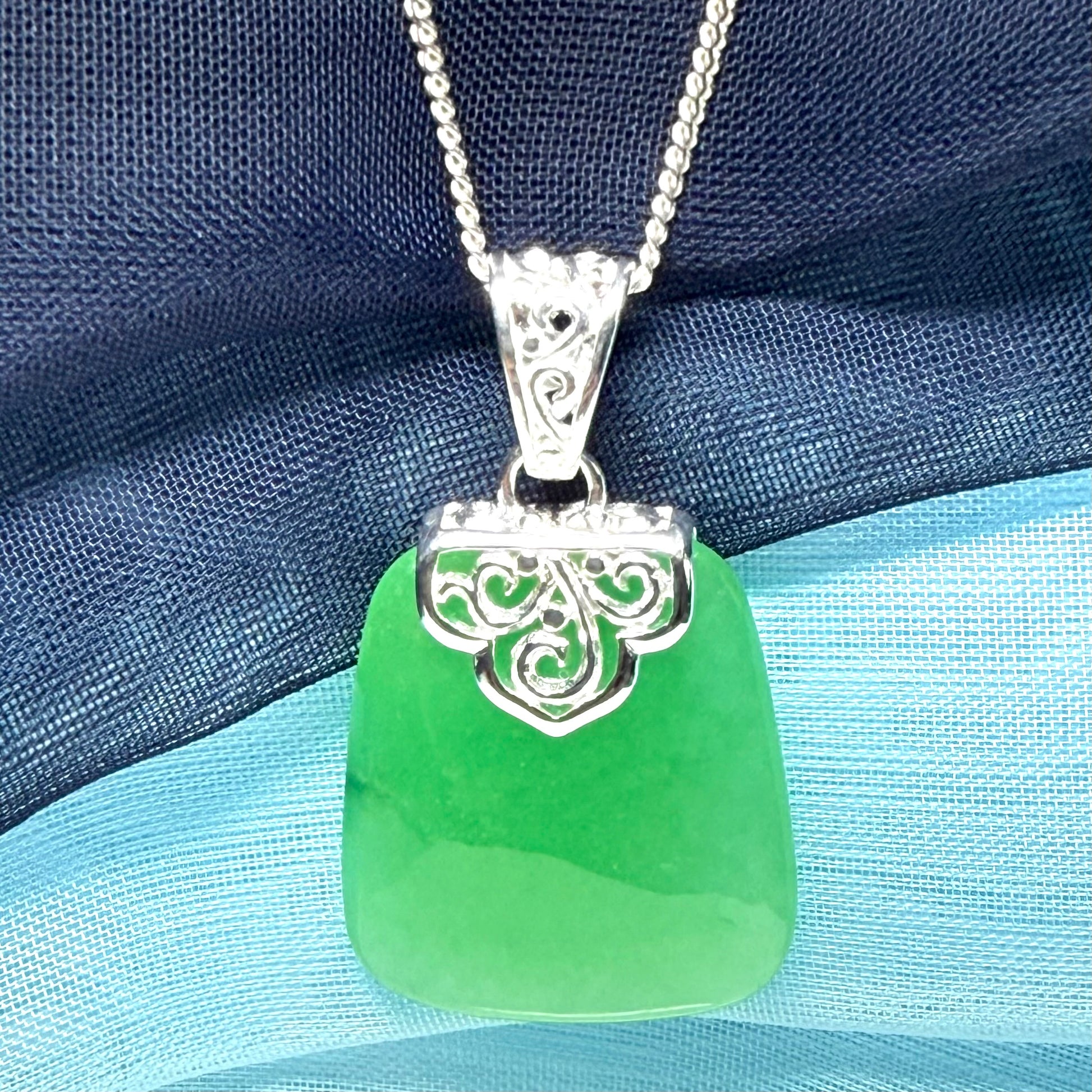 Green real jade necklace with a large shaped and patterned pendant with chain