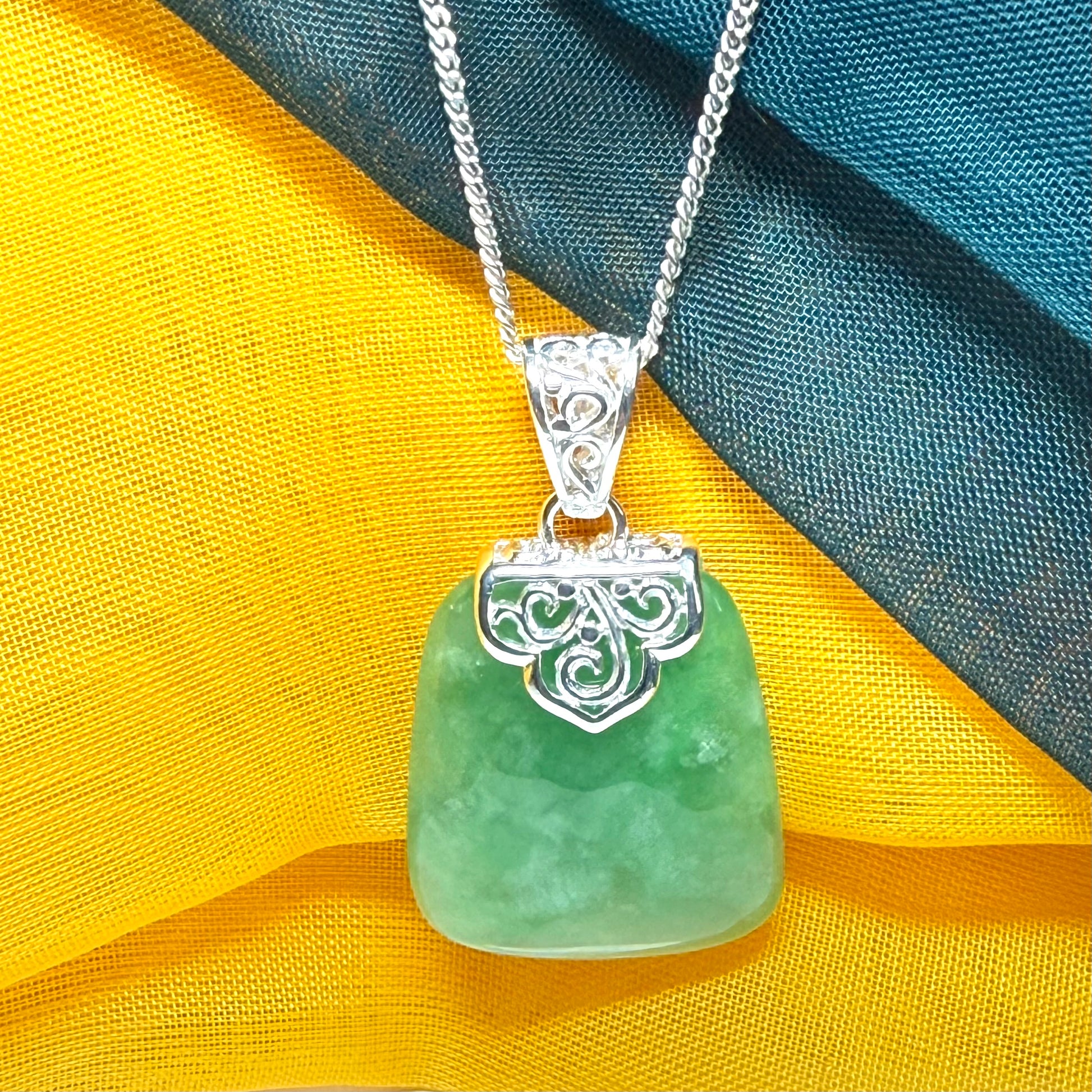 Green real jade necklace with a large shaped and patterned pendant