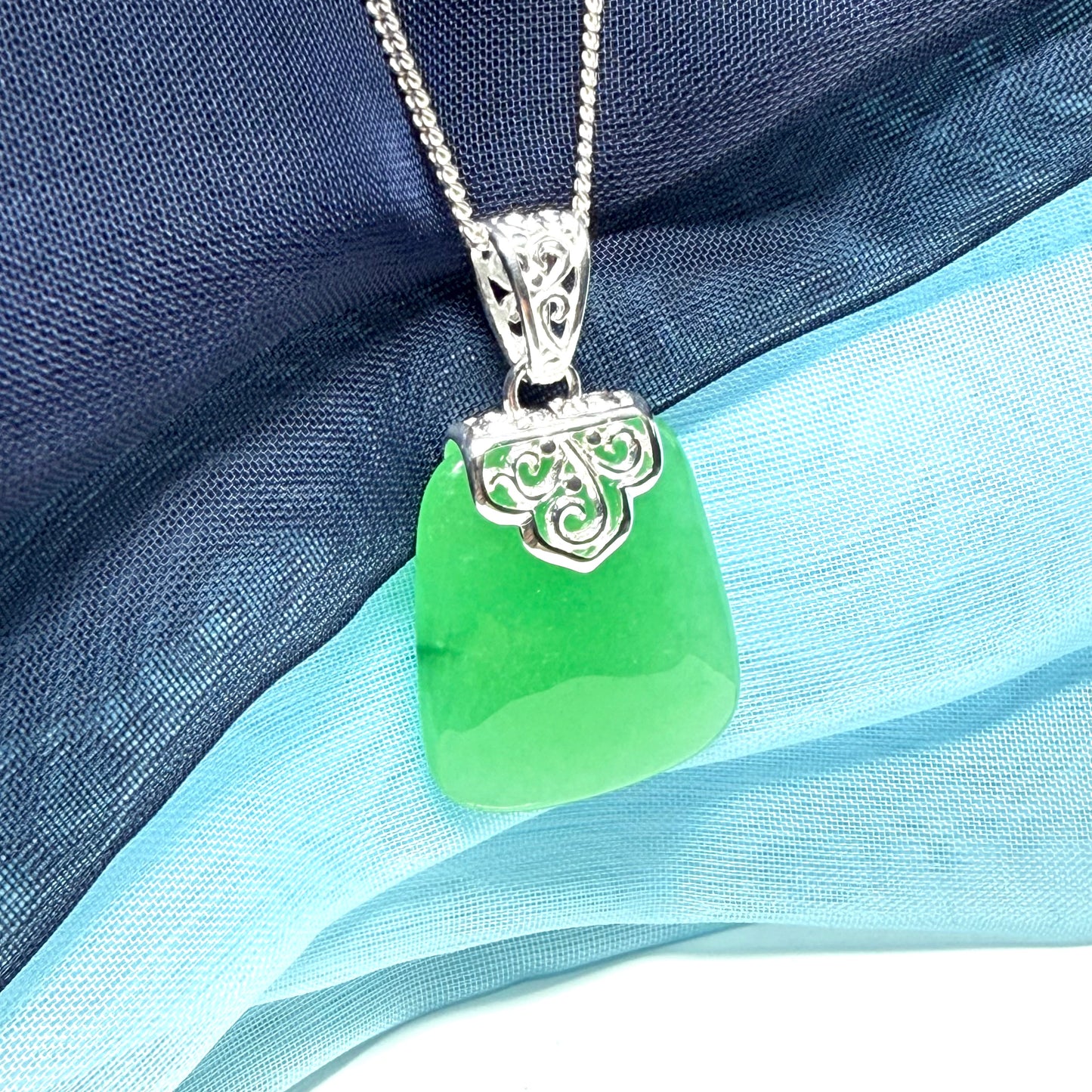 Green real jade necklace with a large shaped and patterned pendant with chain