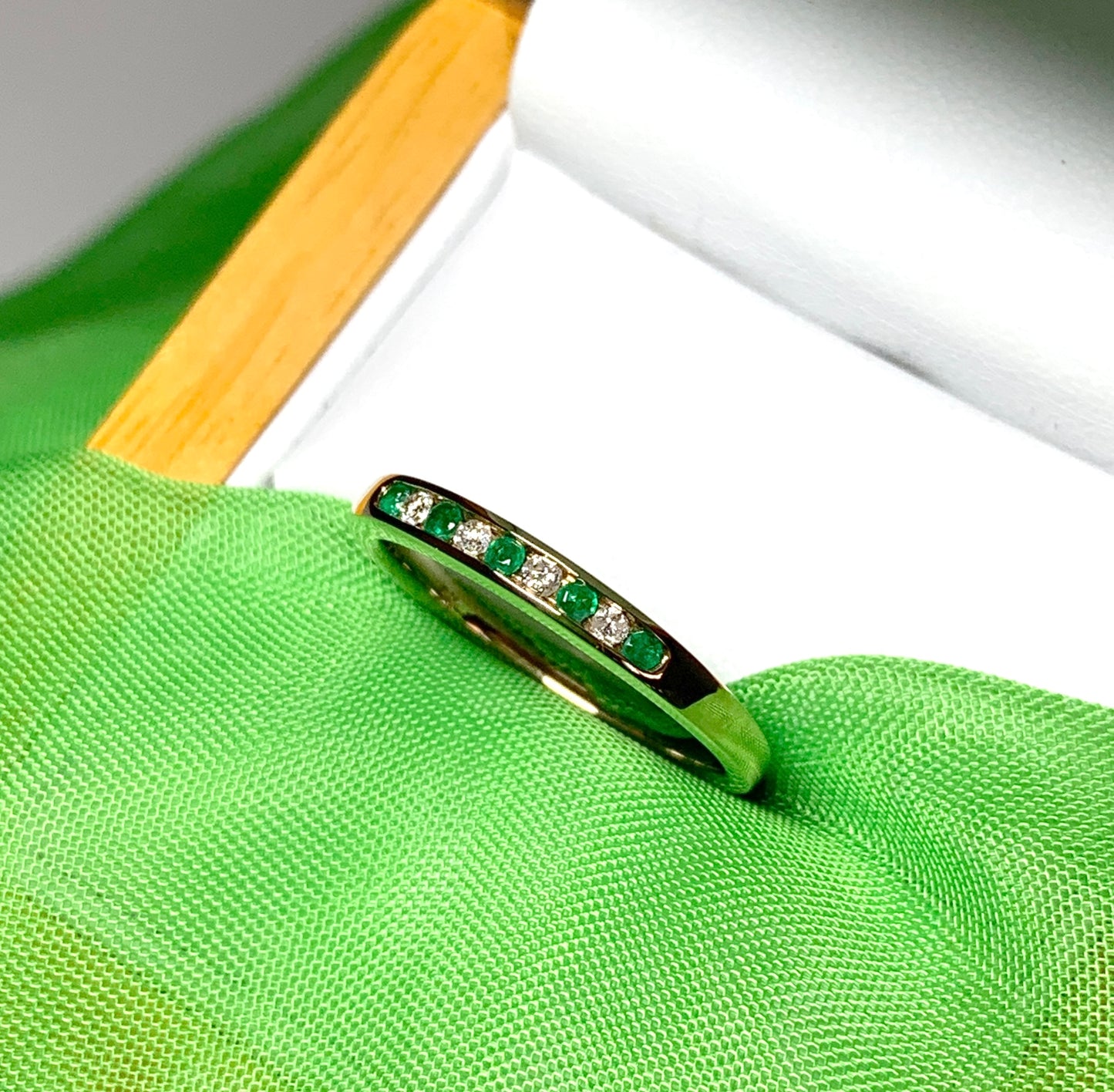 Green real emerald and diamond yellow gold channel set eternity ring