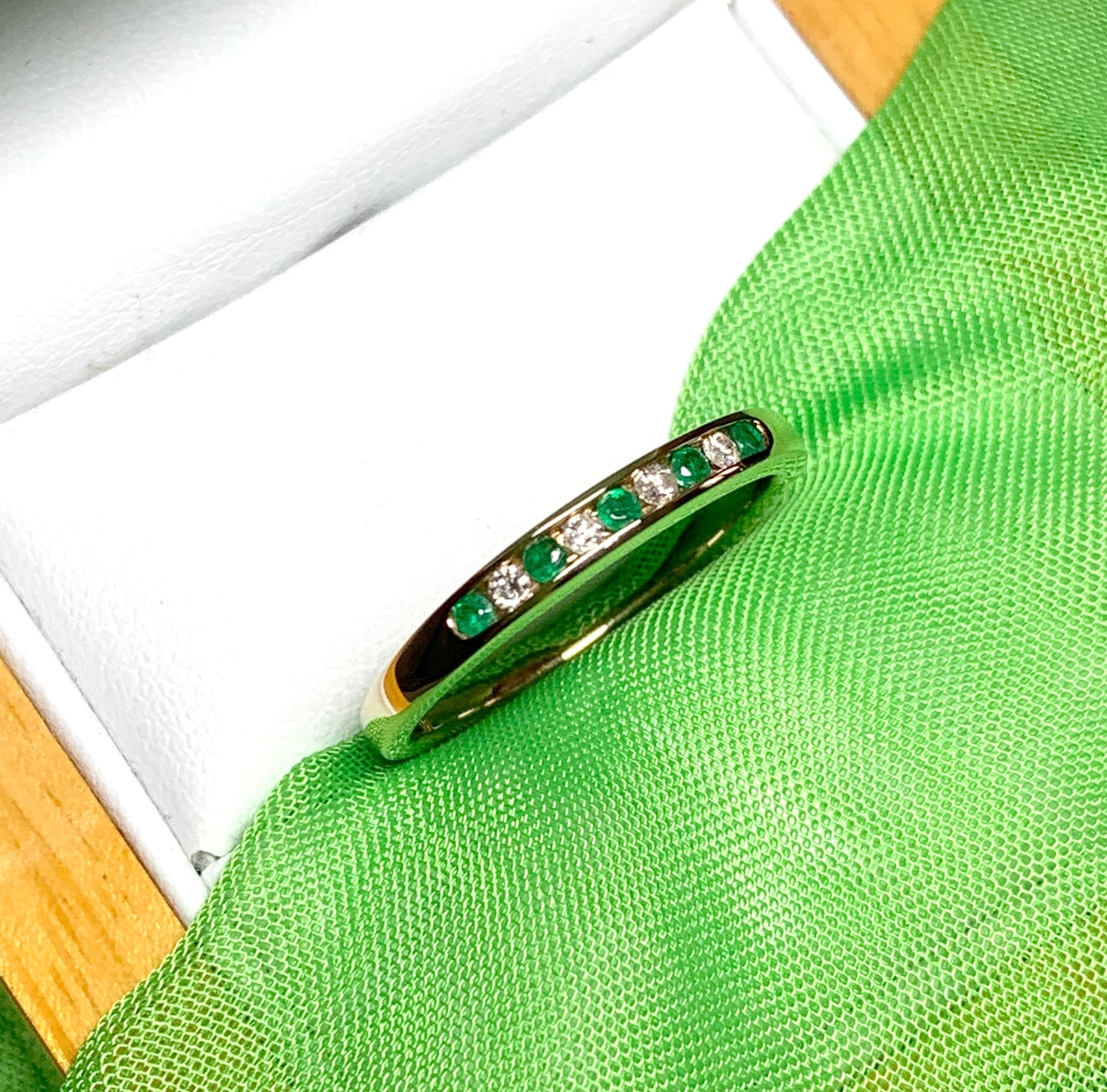 Green real emerald and diamond yellow gold channel set eternity ring