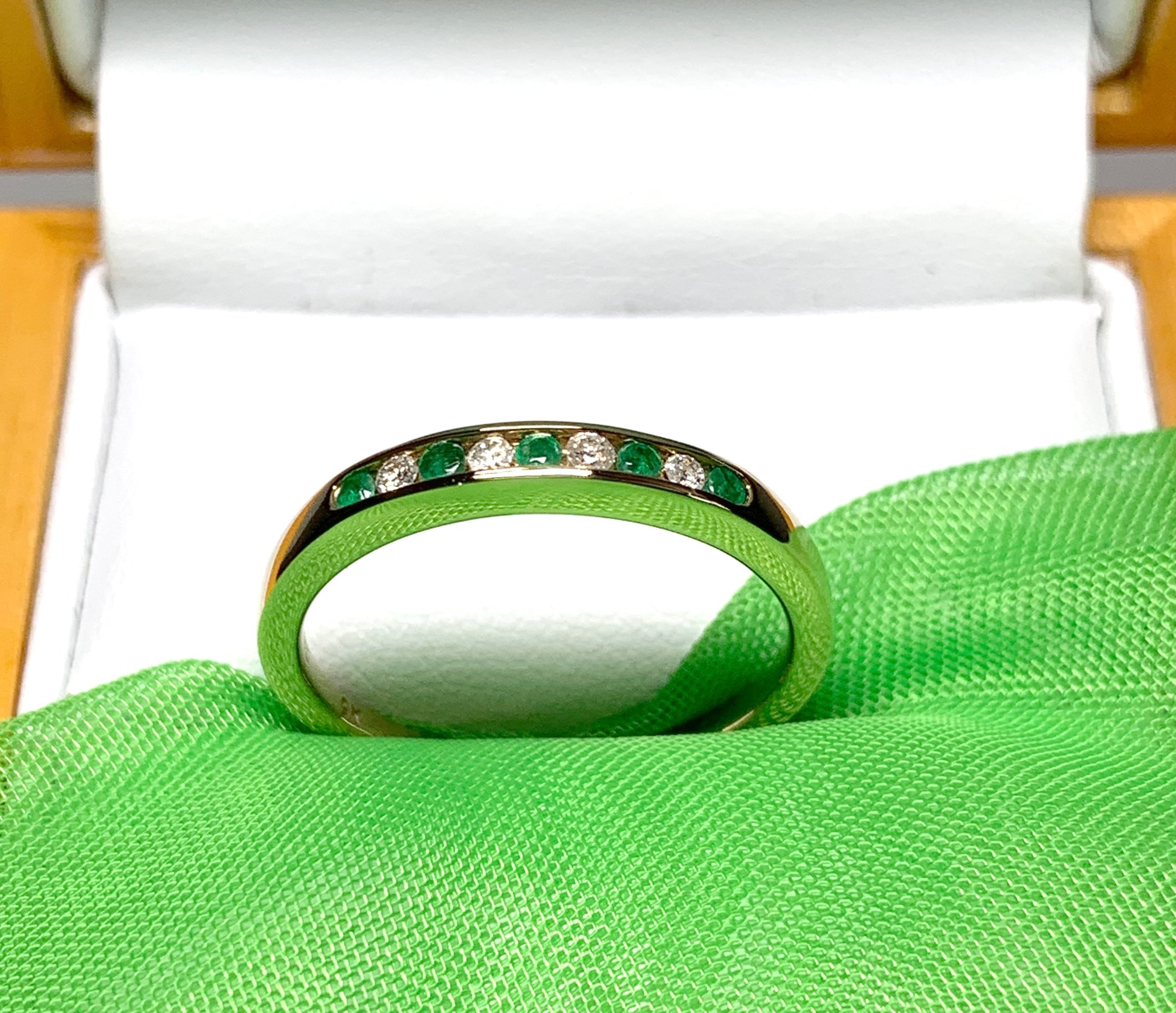 Green real emerald and diamond yellow gold channel set eternity ring