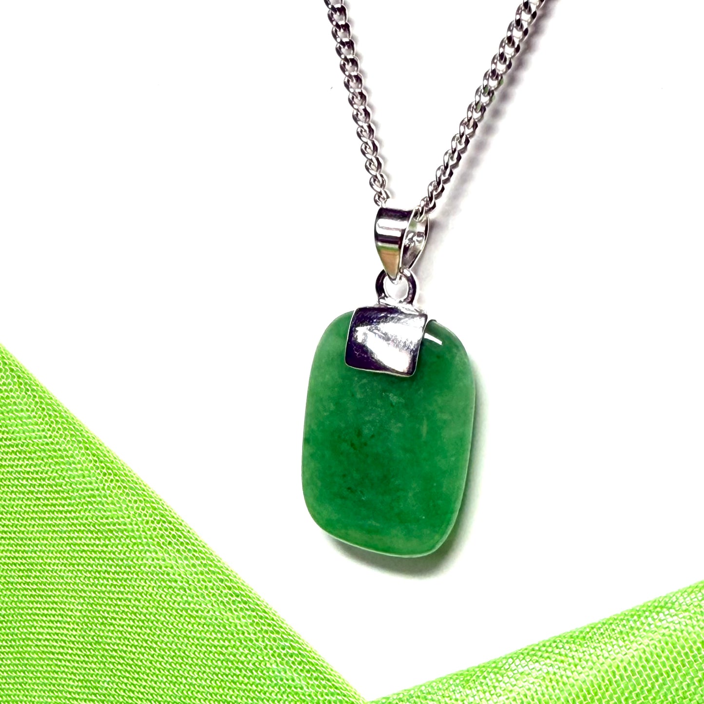 A necklace pendant having a real green jade sterling silver cushion shaped