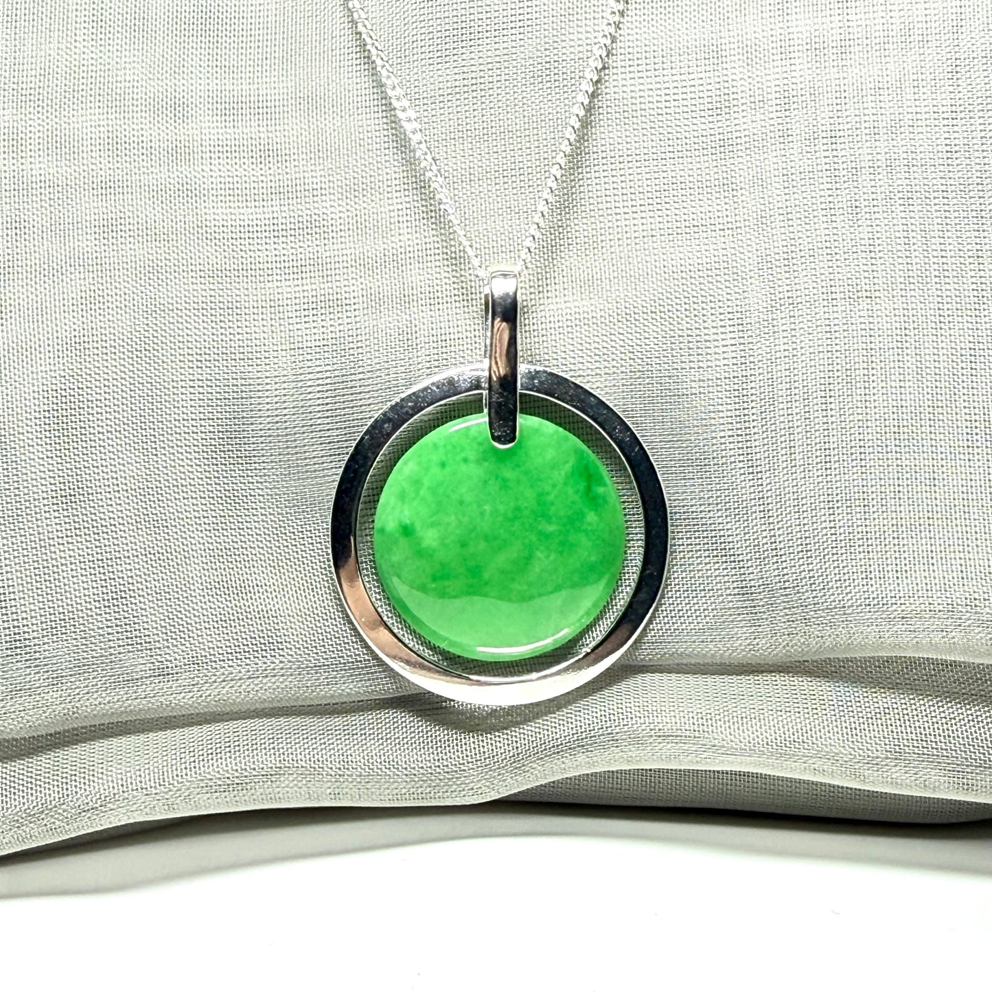 A large sterling silver green real jade necklace halo style, a gorgeous designed round pendant