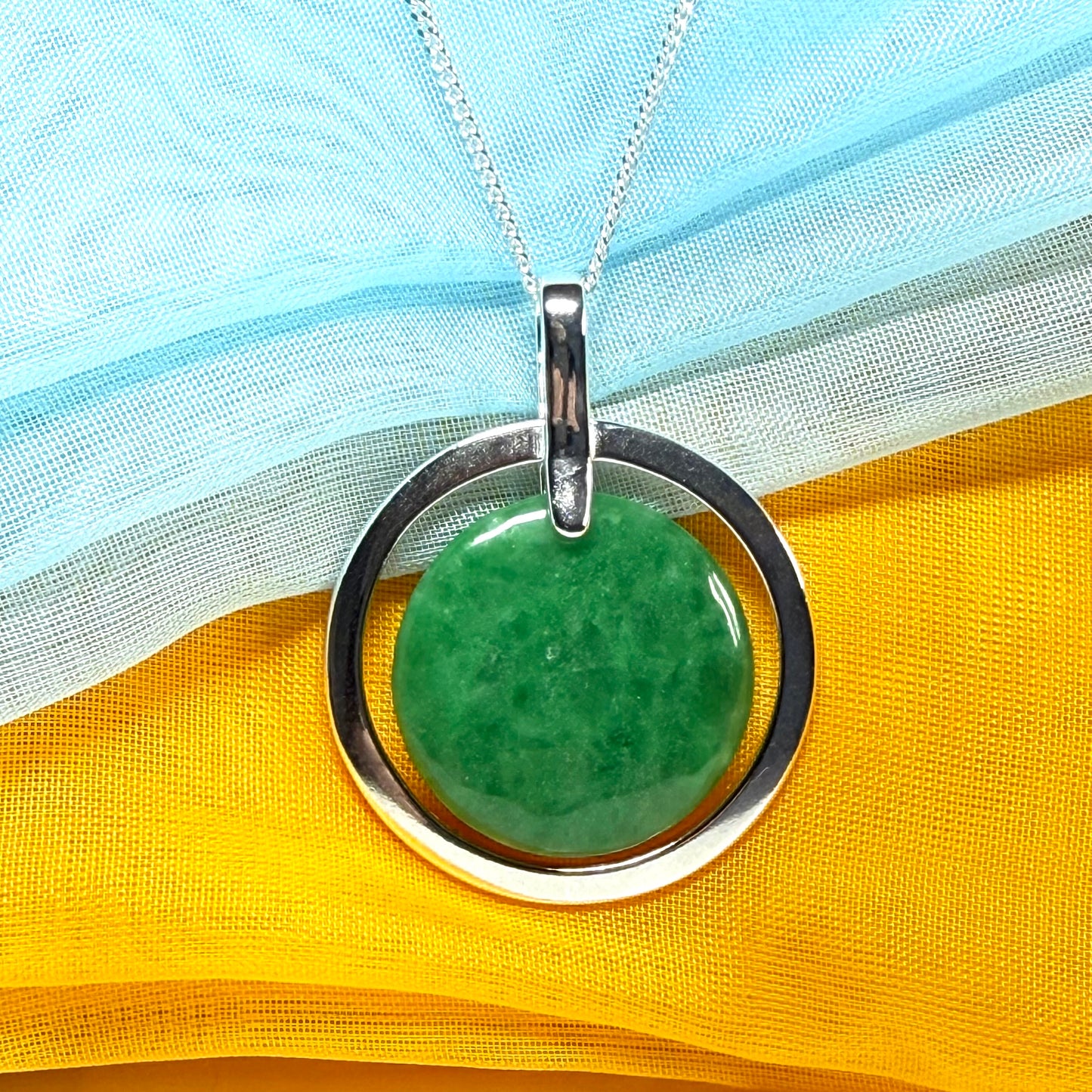 A large gorgeous sterling silver green real jade necklace halo style round pendant