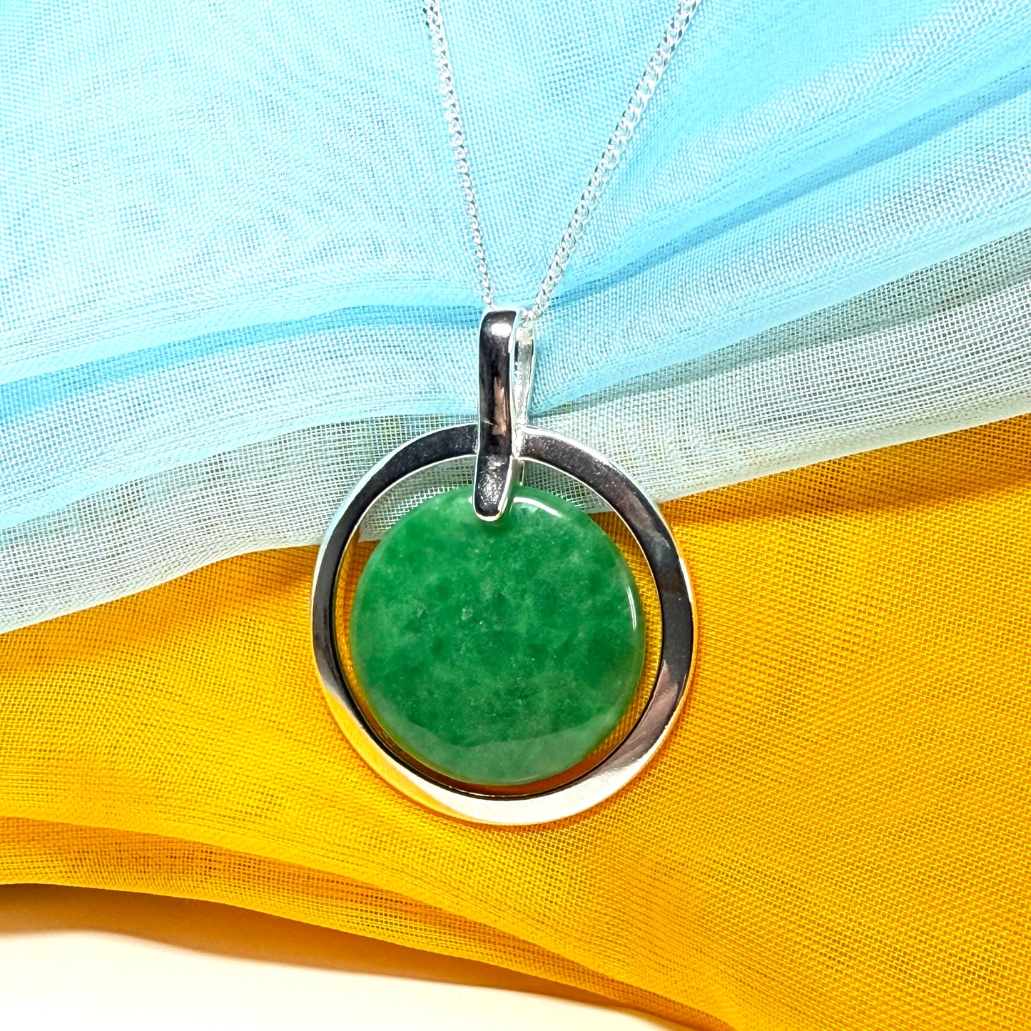 A large gorgeous sterling silver green real jade necklace halo style round pendant