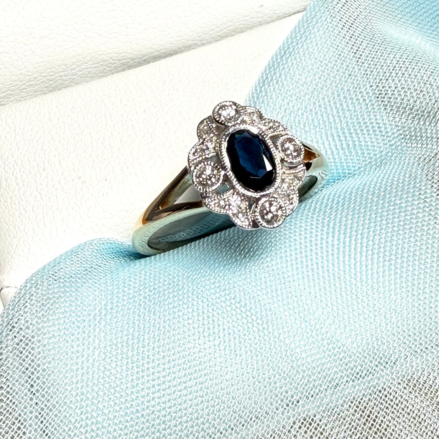 Dark blue sapphire and diamond yellow gold cluster ring