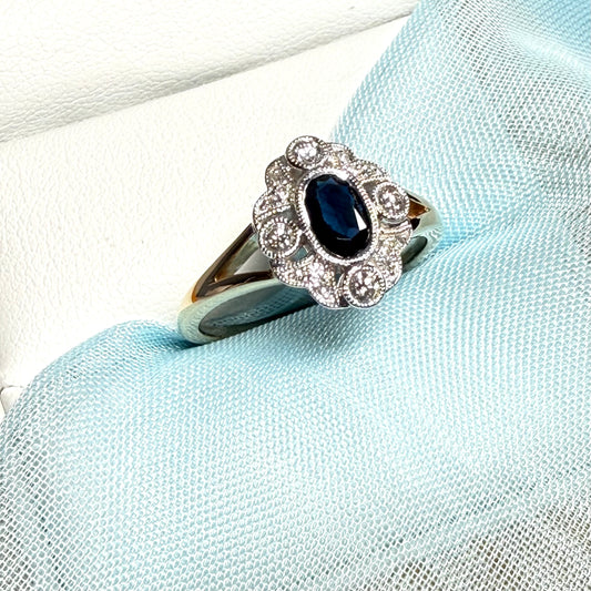 Dark blue sapphire and diamond yellow gold cluster ring