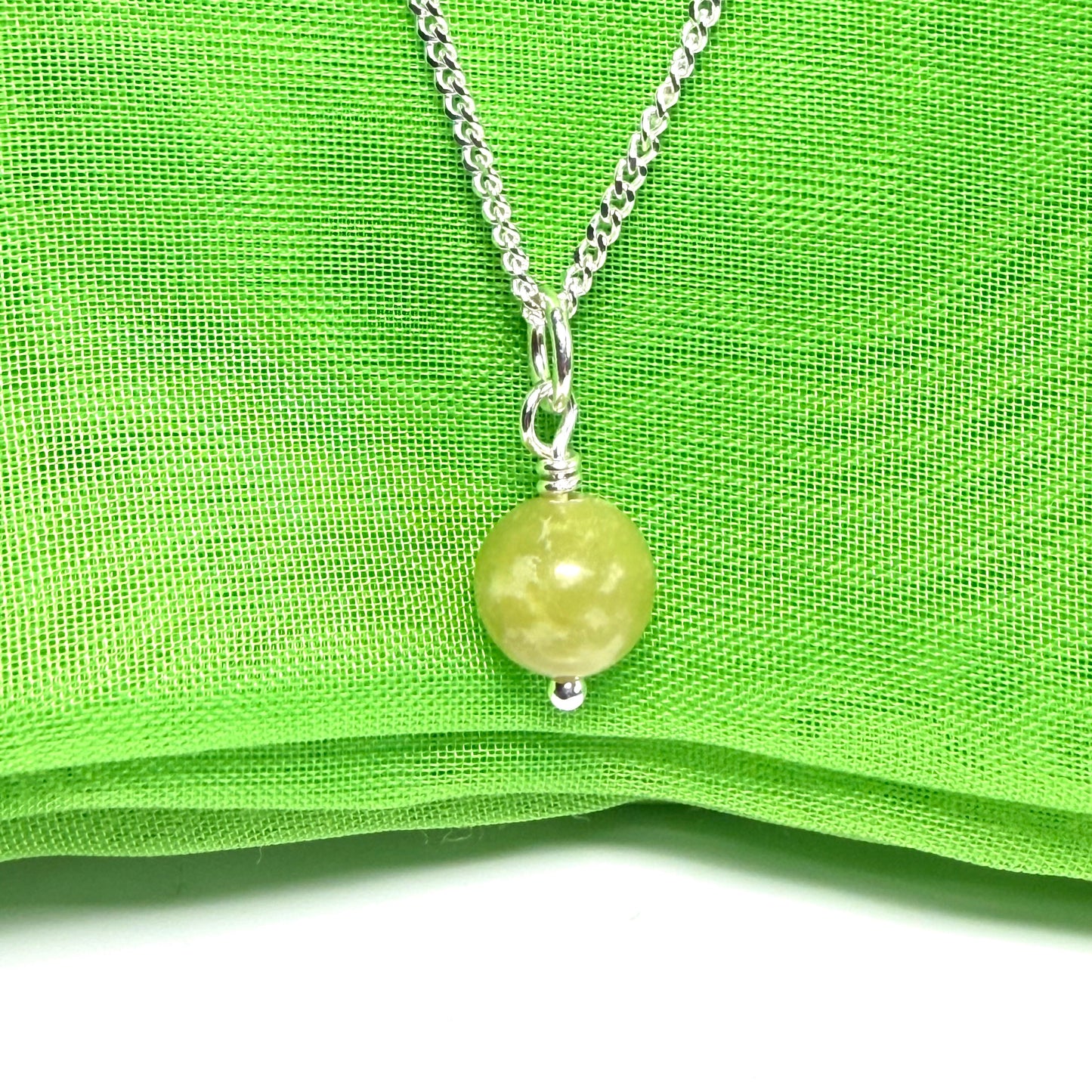 A small real green gypsum necklace ball shaped, a really gorgeous round pendant with chain too