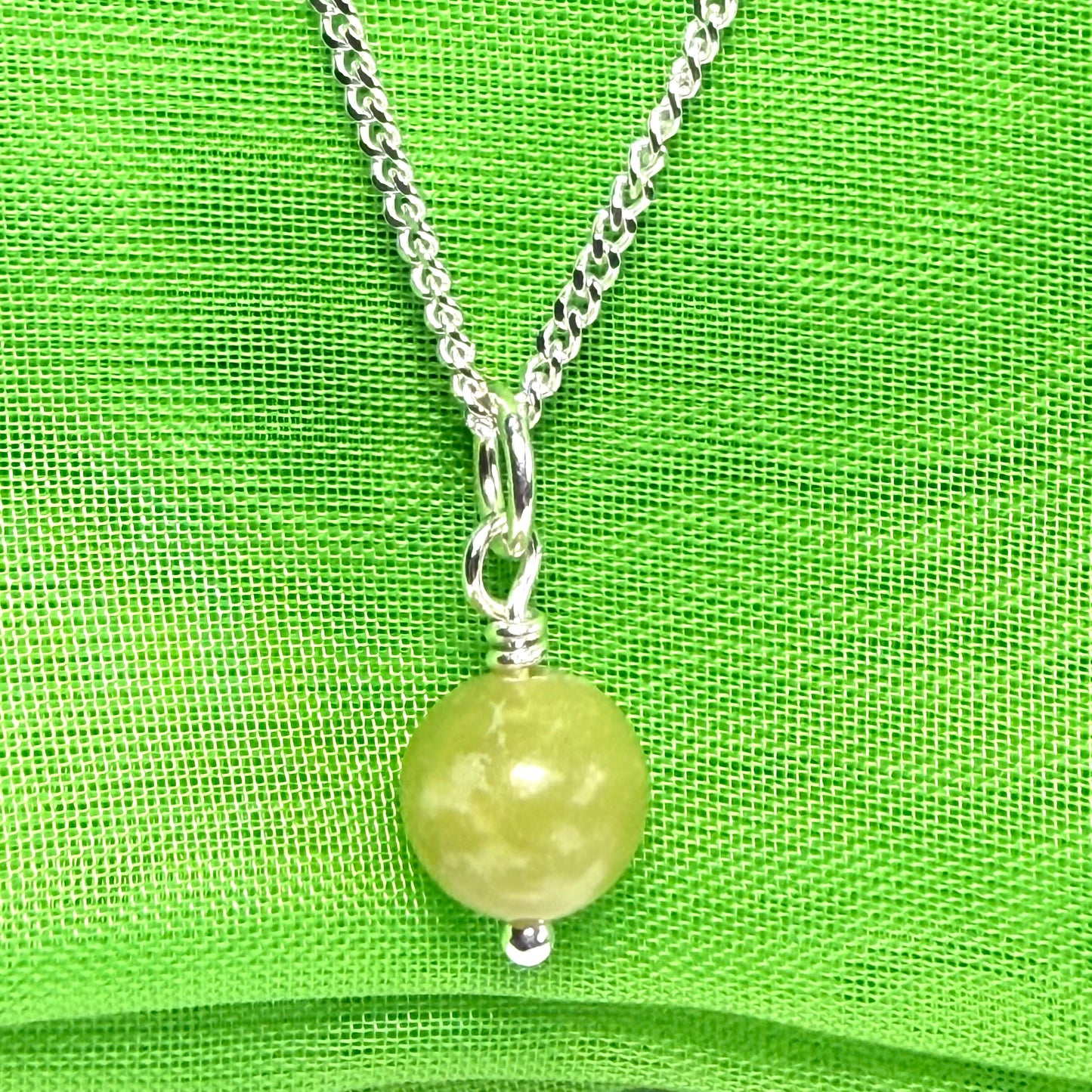 A small real green gypsum necklace ball shaped, a really gorgeous round pendant with chain too