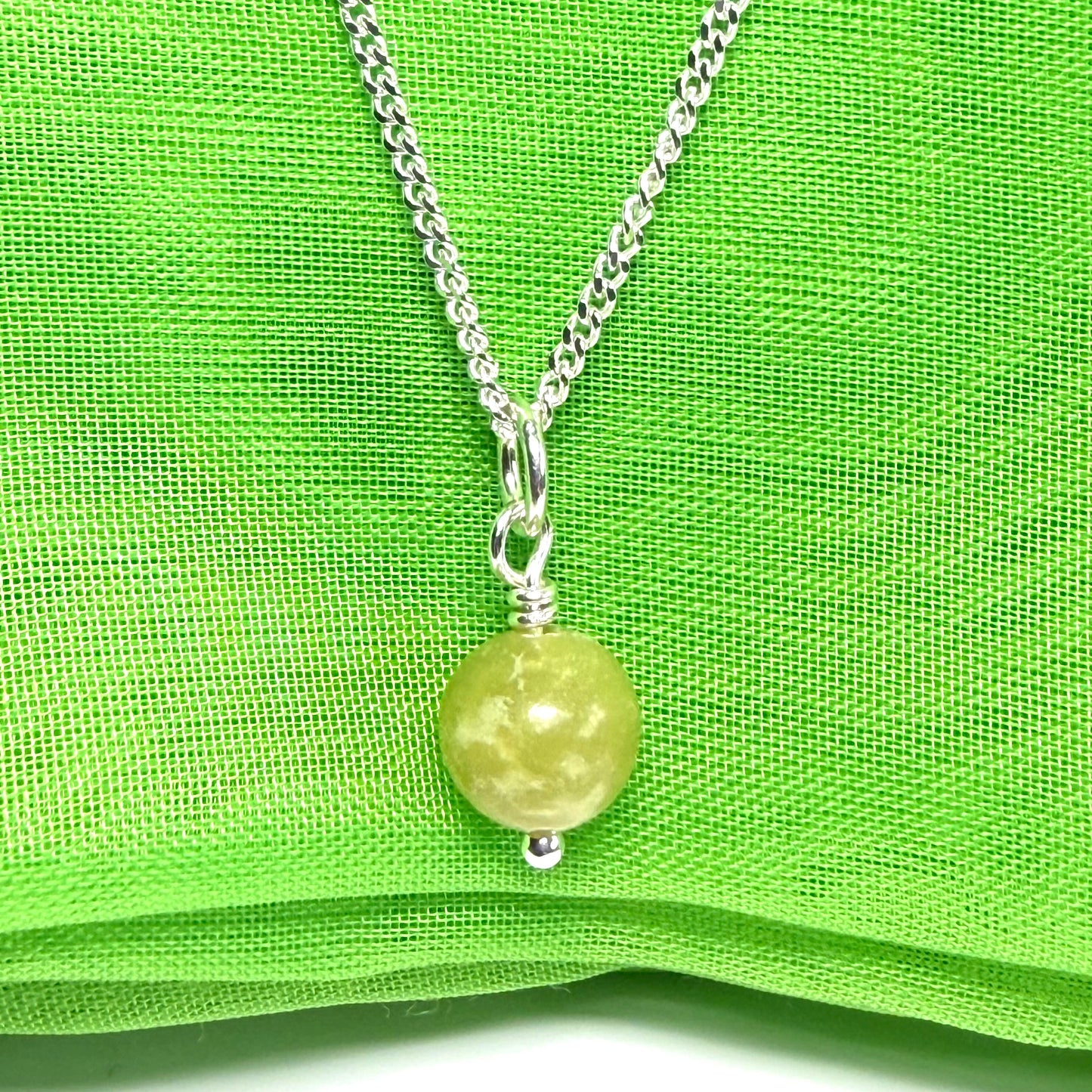 A small real green gypsum necklace ball shaped, a really gorgeous round pendant with chain too