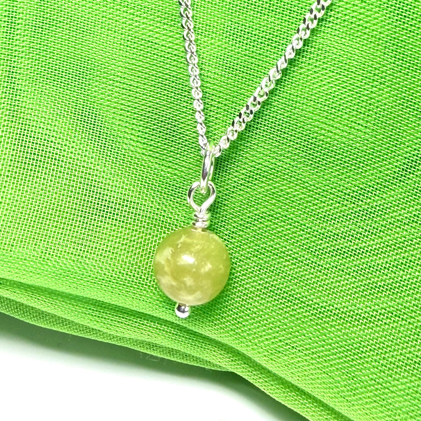 A small real green gypsum necklace ball shaped, a really gorgeous round pendant with chain too