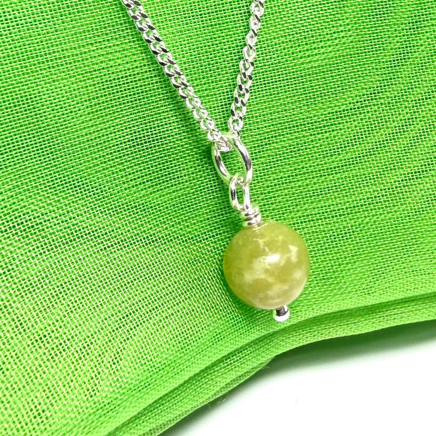 A small real green gypsum necklace ball shaped, a really gorgeous round pendant with chain too