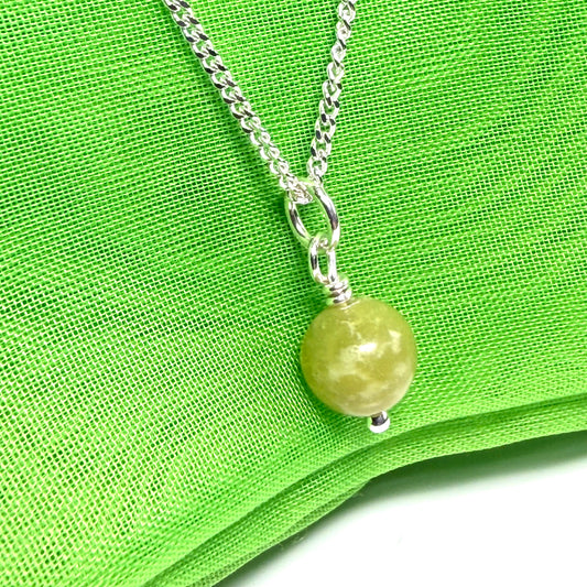 A small real green gypsum necklace ball shaped, a really gorgeous round pendant with chain too