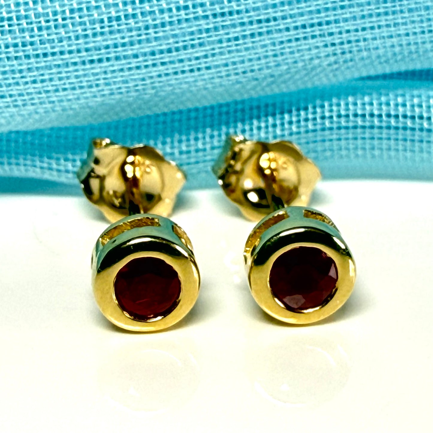 Pair of real red ruby earrings round yellow gold stud smooth rubbed over setting