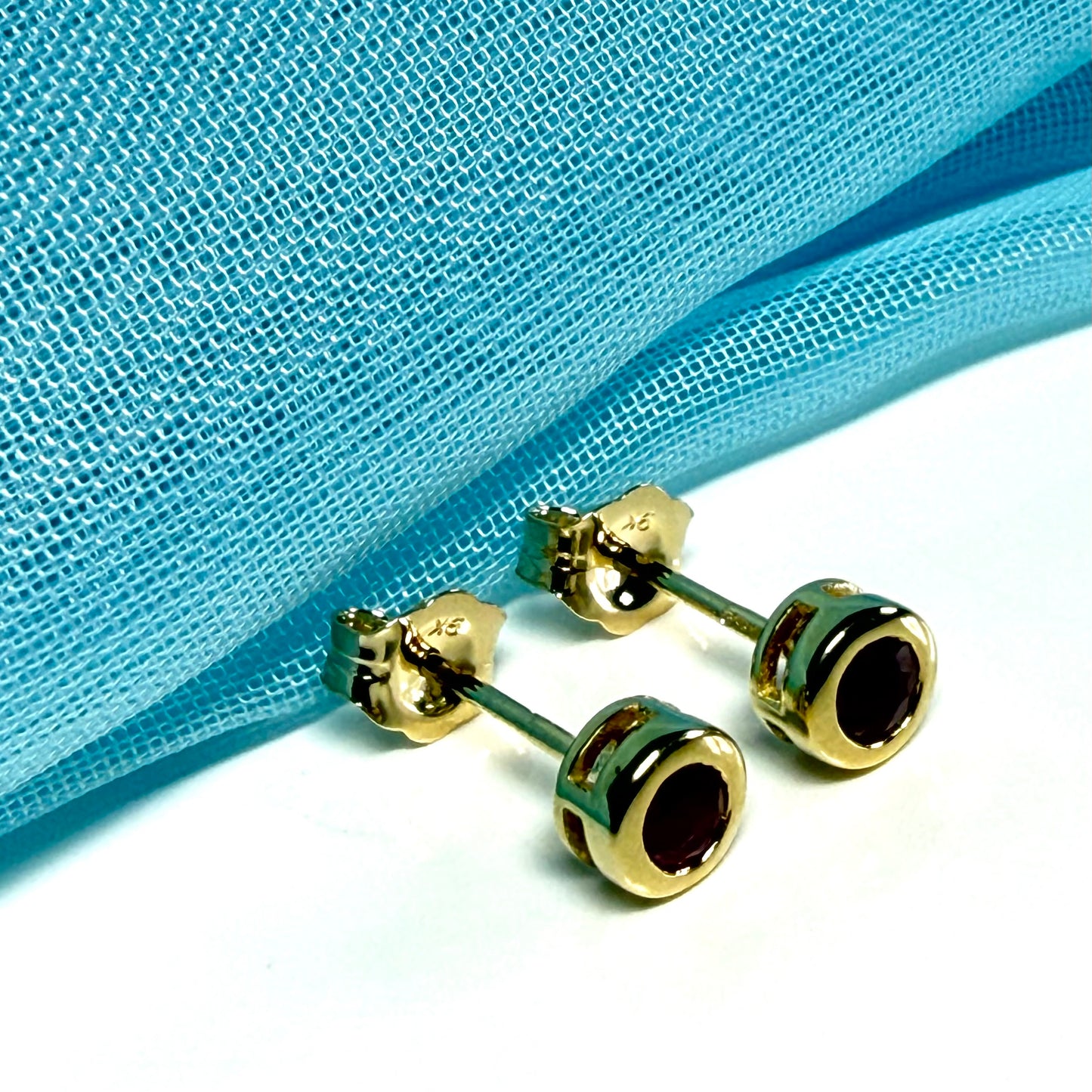 Pair of real red ruby earrings round yellow gold stud smooth rubbed over setting