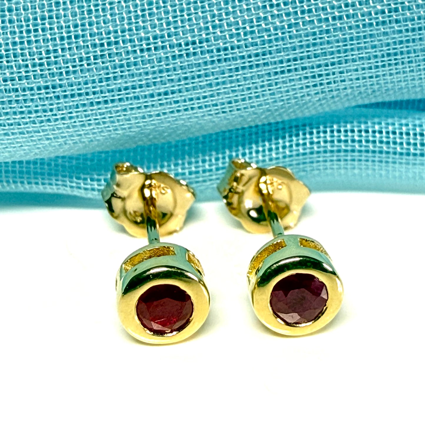 Pair of real red ruby earrings round yellow gold stud smooth rubbed over setting