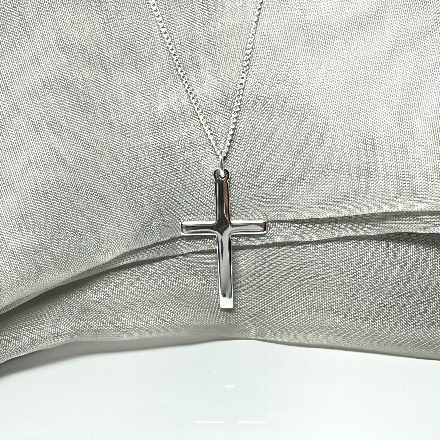 Cross and chain highly polished with a round pendant loop on top of it
