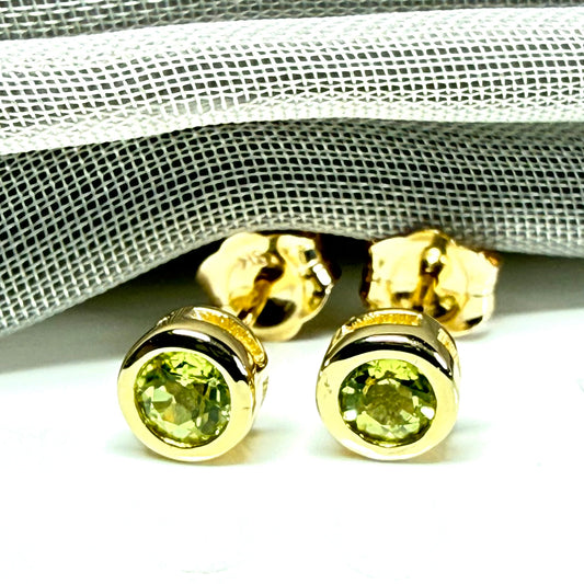 Pair of real green peridot earrings round yellow gold stud smooth rubbed over setting