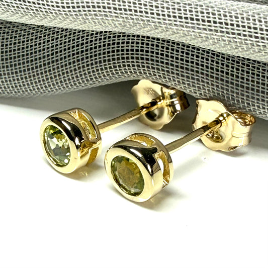 Pair of real green peridot earrings round yellow gold stud smooth rubbed over setting