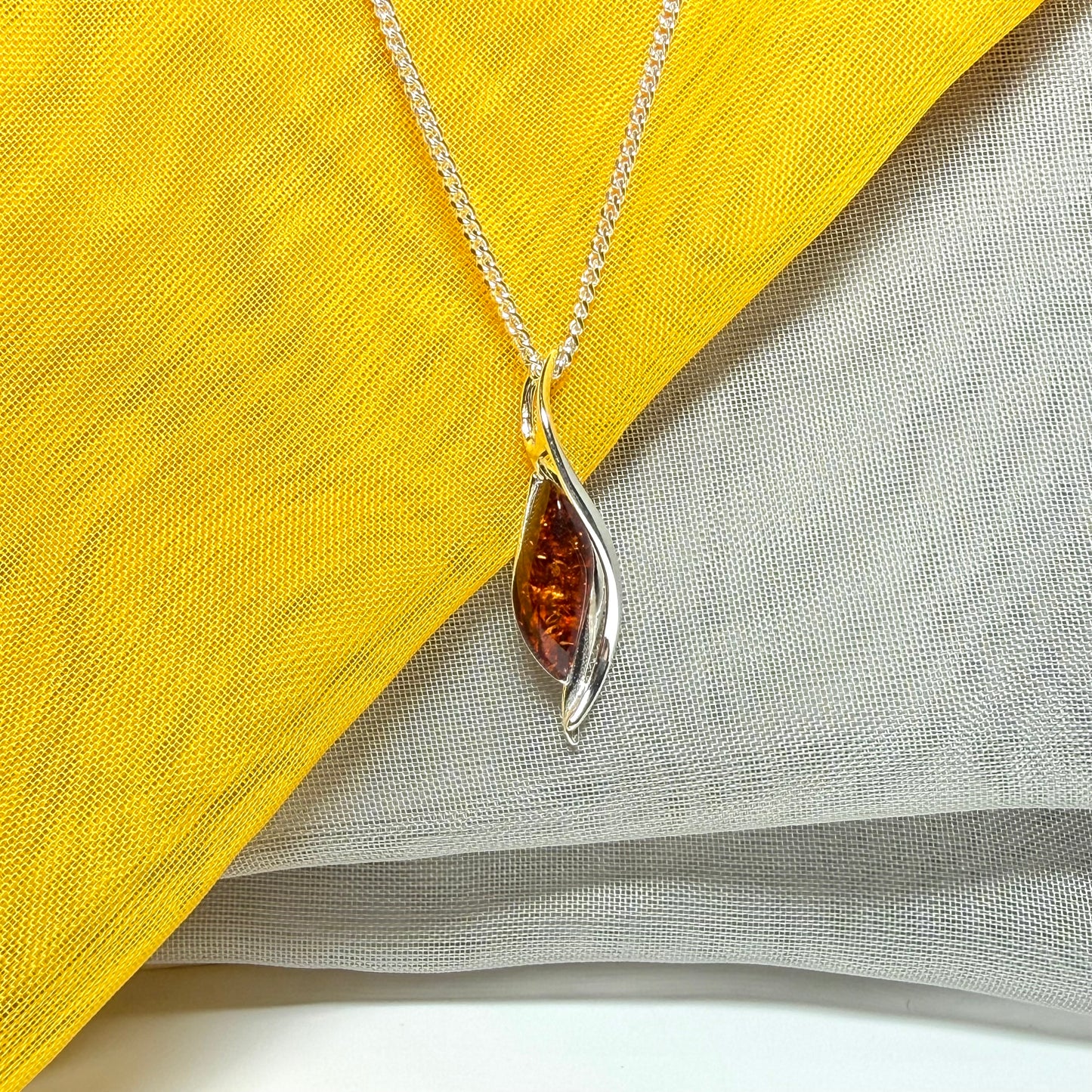 A real amber necklace sterling silver twisted marquise shaped amber pendant