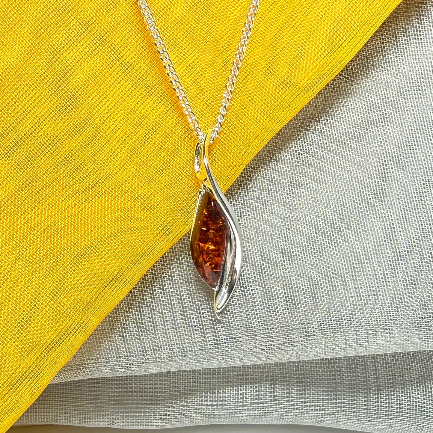 A real amber necklace sterling silver twisted marquise shaped amber pendant