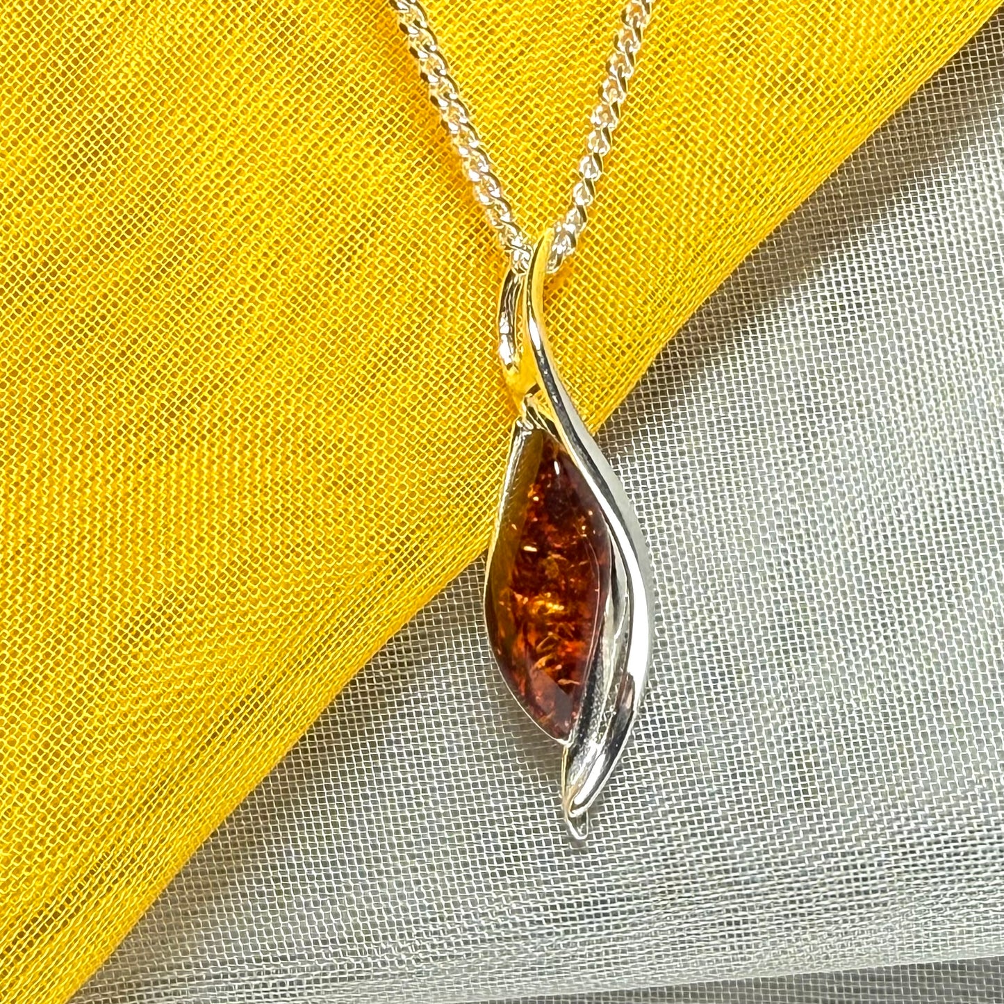 A real amber necklace sterling silver twisted marquise shaped amber pendant