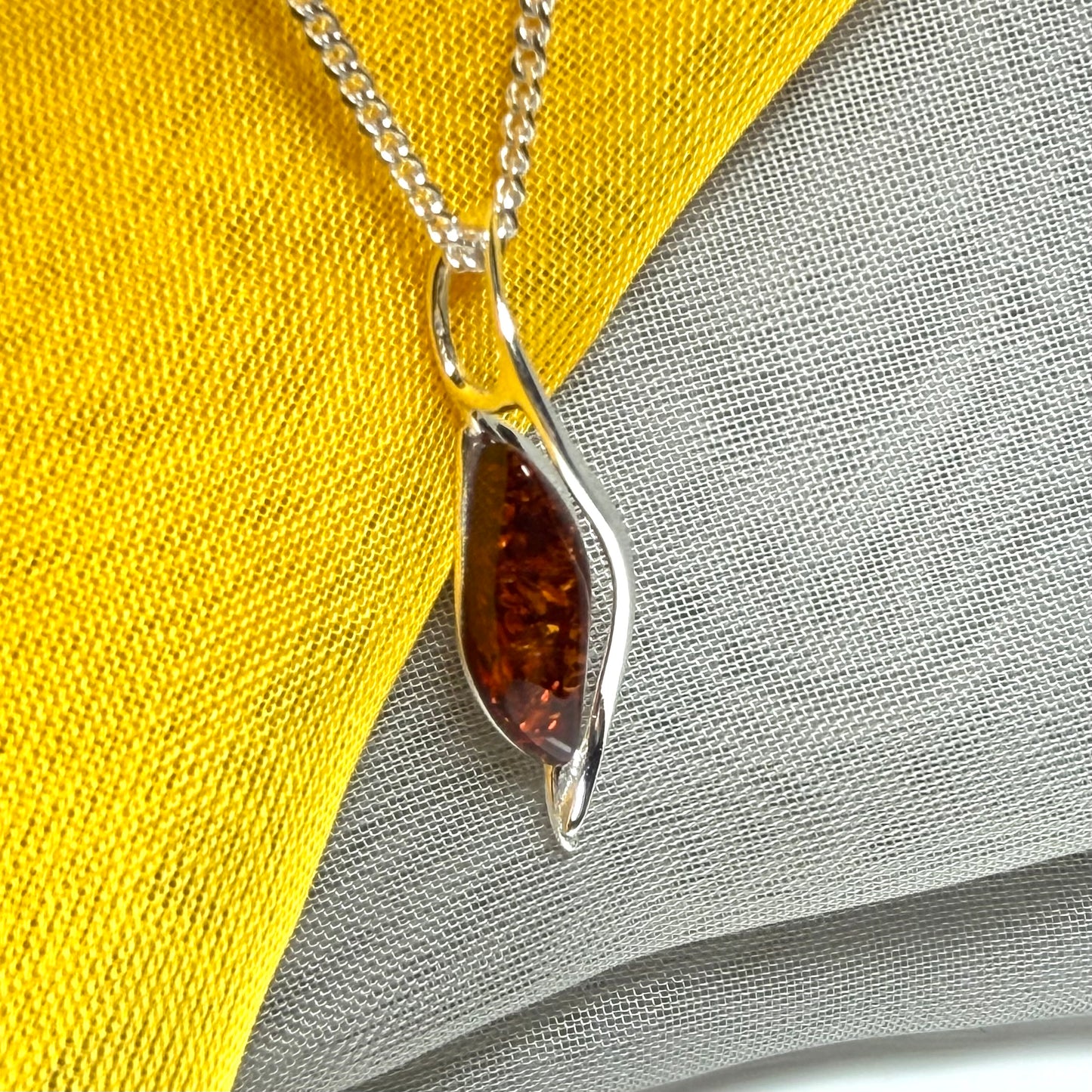 A real amber necklace sterling silver twisted marquise shaped amber pendant