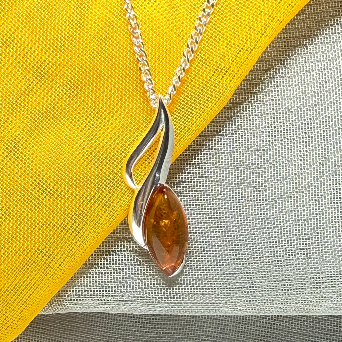 A sterling silver real amber marquise shape necklace open pierced pendant with a chain