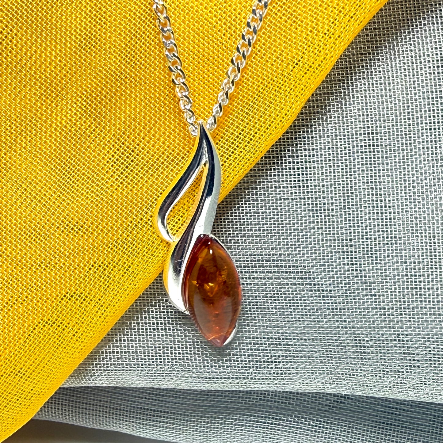 A sterling silver real amber marquise shape necklace open pierced pendant with a chain