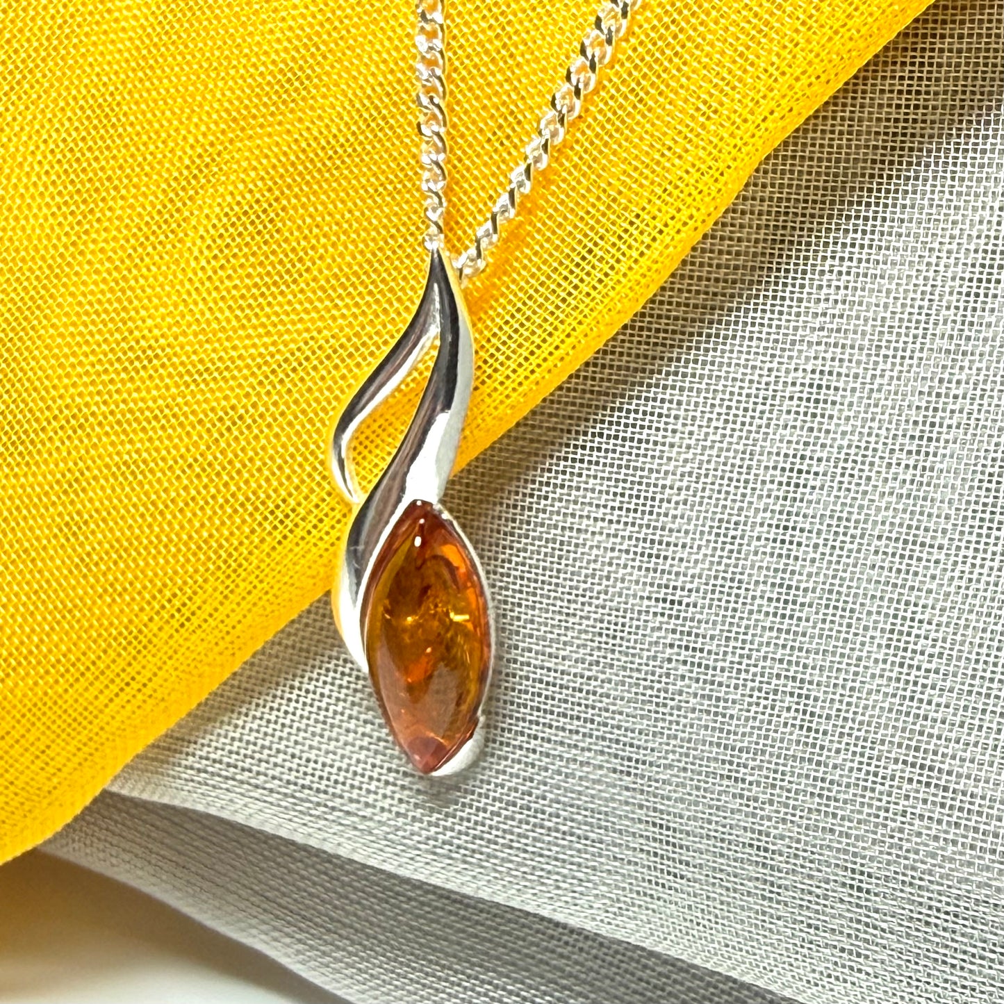 A sterling silver real amber marquise shape necklace open pierced pendant with a chain