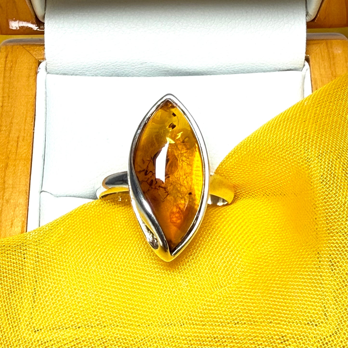 Large sterling silver real amber ring marquise shaped with a swirl