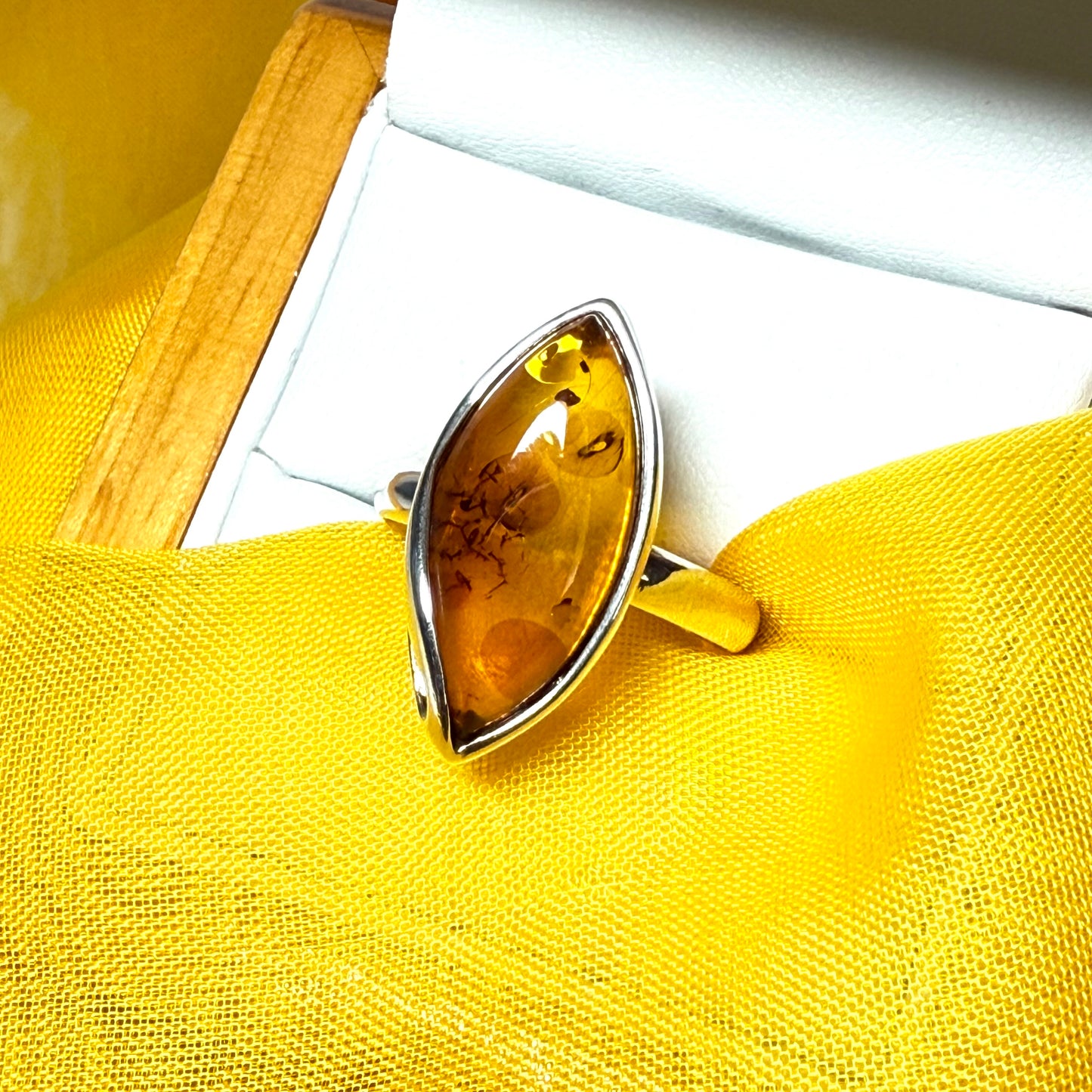 Large sterling silver real amber ring marquise shaped with a swirl