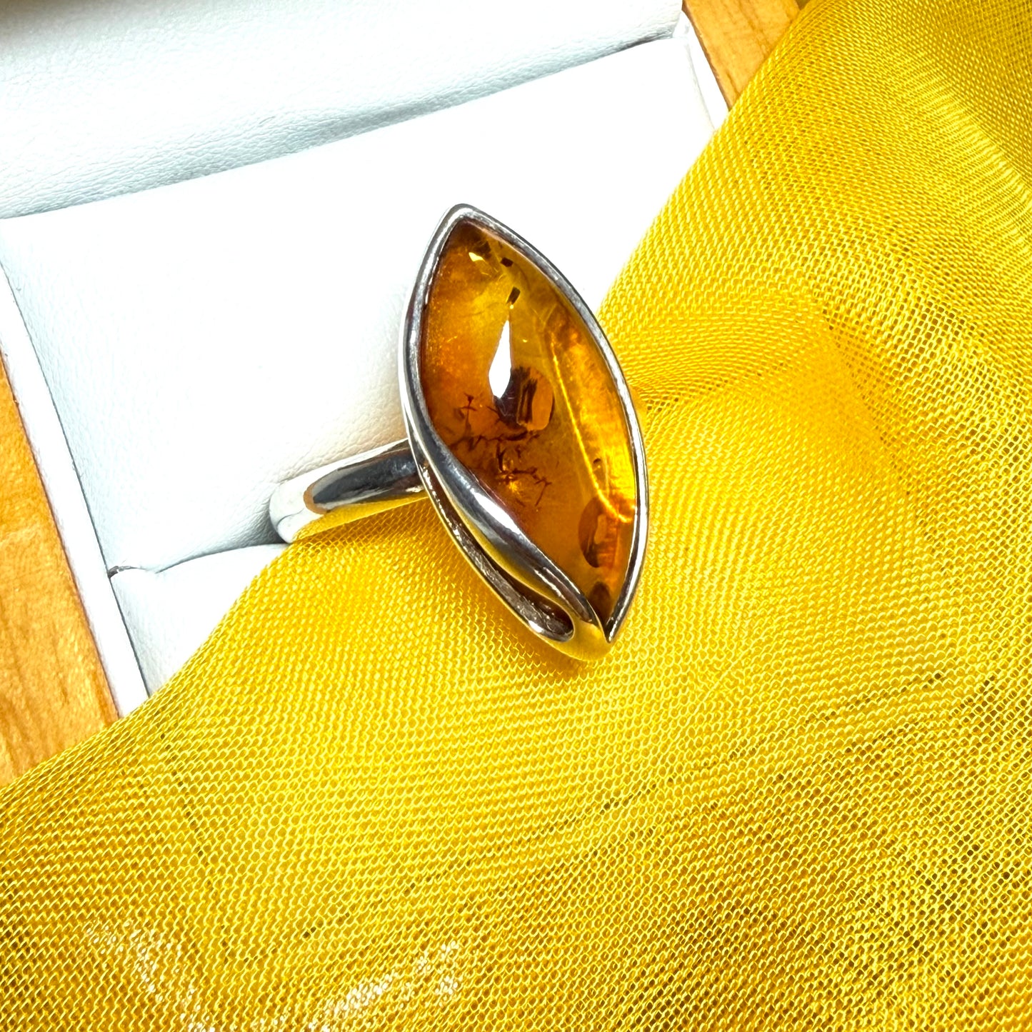 Large sterling silver real amber ring marquise shaped with a swirl