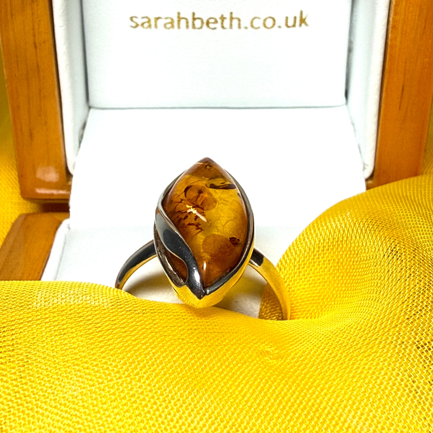 Large sterling silver real amber ring marquise shaped with a swirl