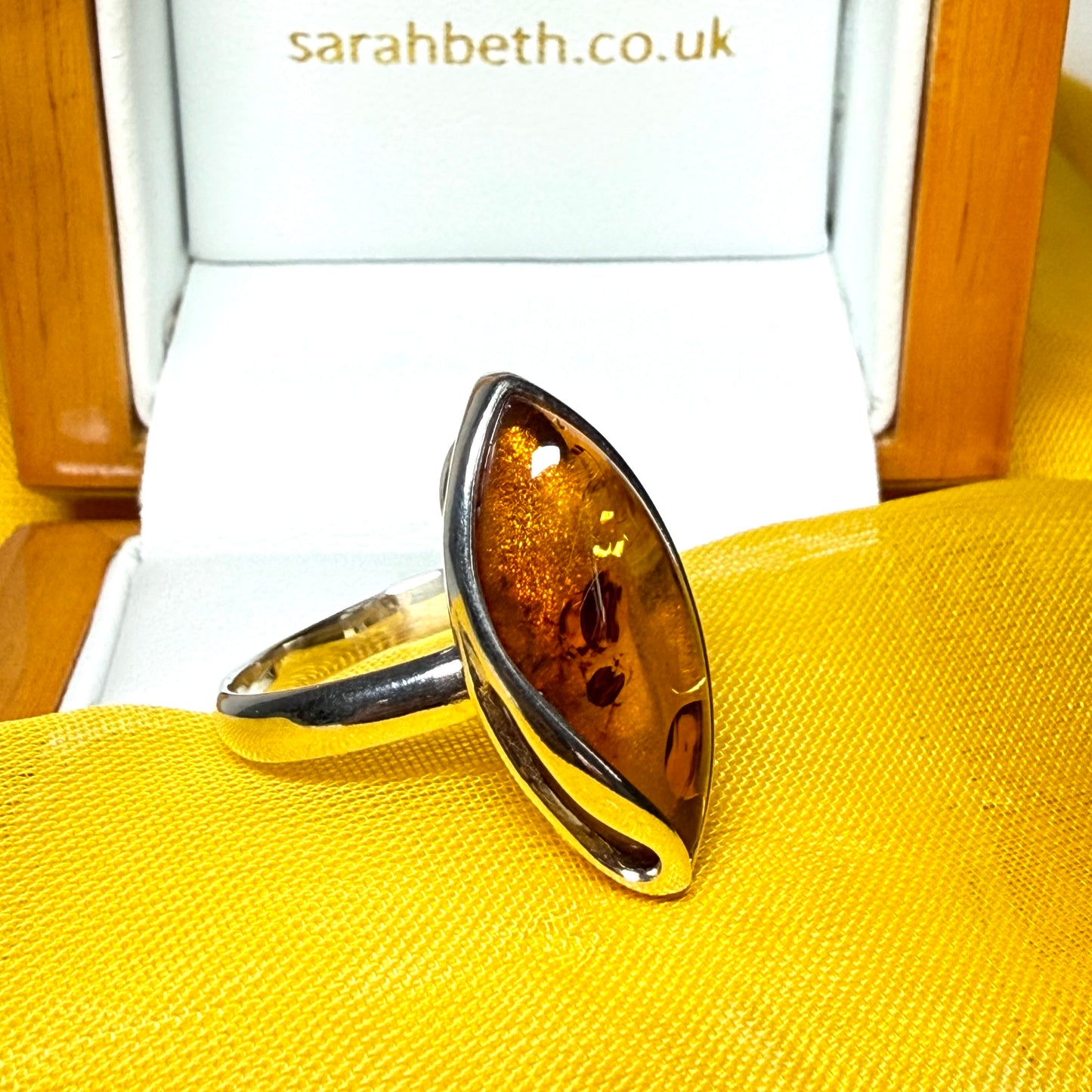 Large sterling silver real amber ring marquise shaped with a swirl