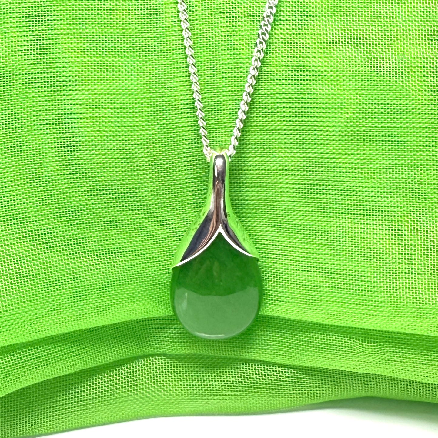 A real green jade pendant teardrop with a pear shaped necklace, with chain included