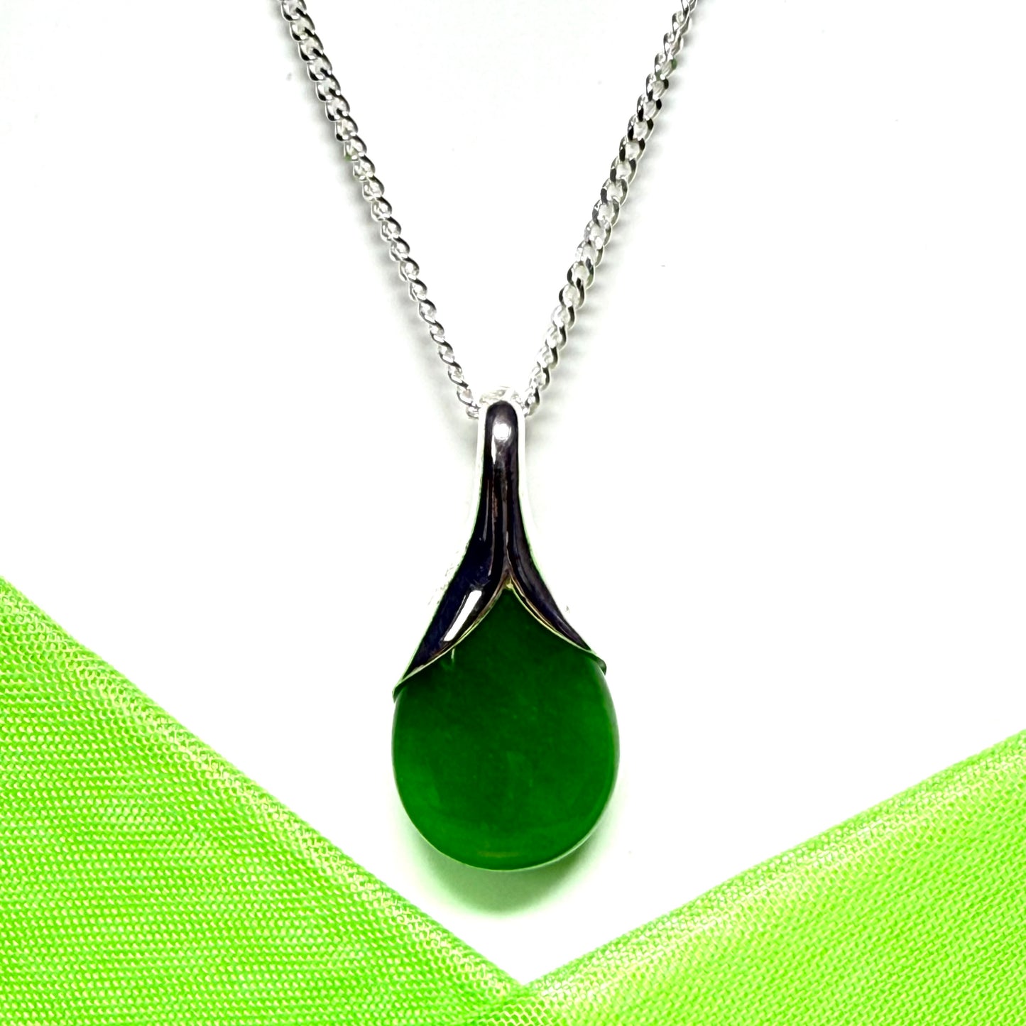 A real green jade pendant teardrop with a pear shaped necklace, with chain included