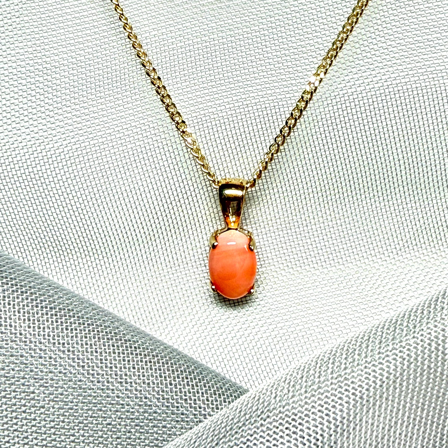 Oval shaped real coral yellow gold necklace pendant with a pierced setting