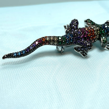 A sterling silver cubic zirconia gecko brooch with real onyx eyes