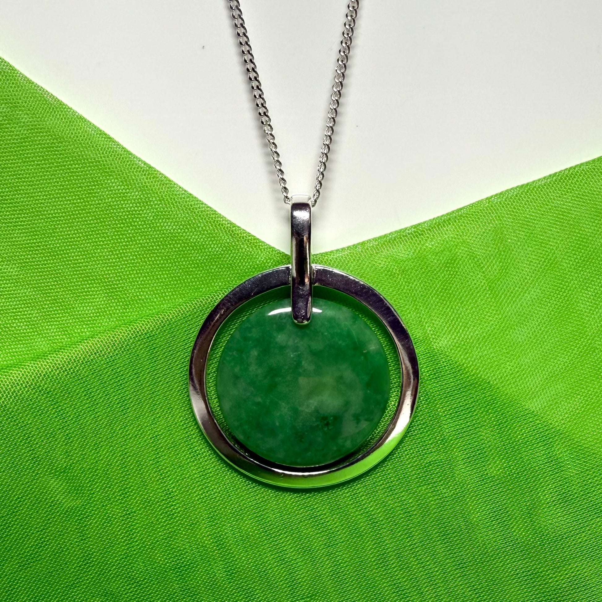 Large silver round shaped dark green real jade necklace with a chain