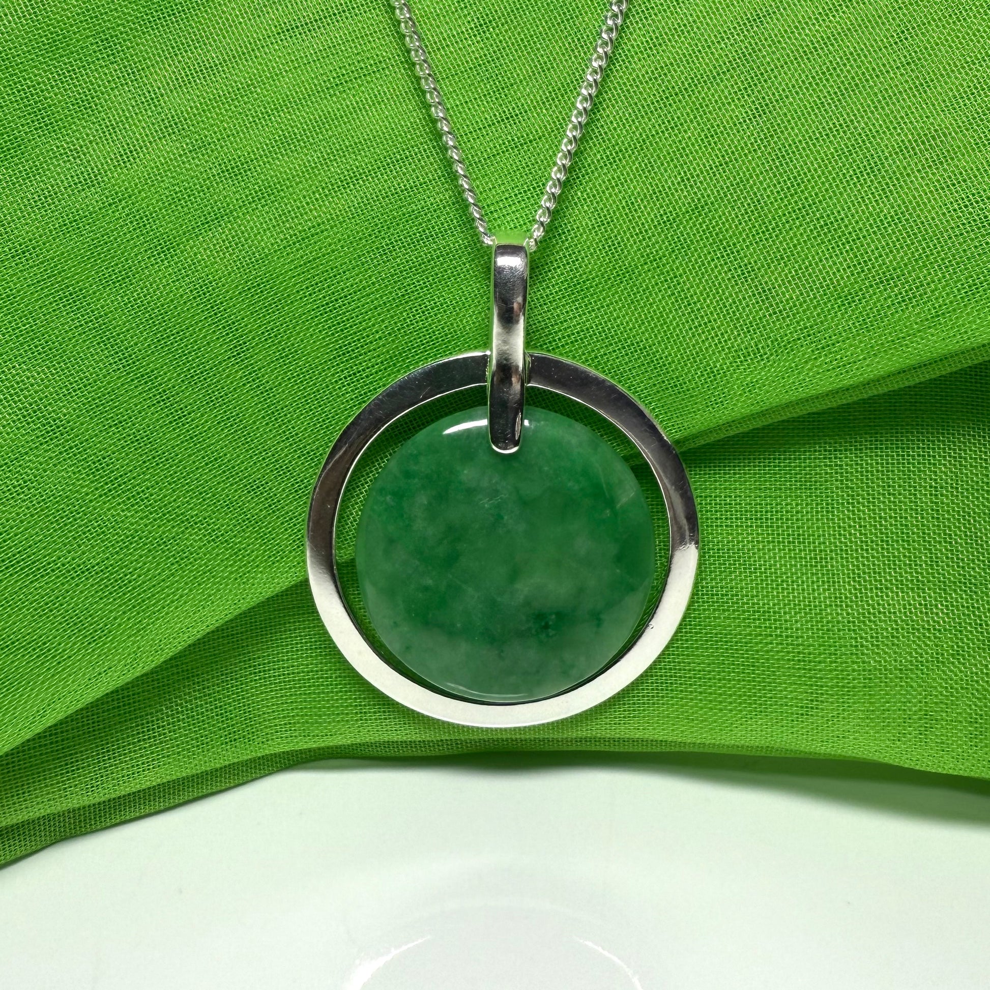 Large silver round shaped dark green real jade necklace with a chain