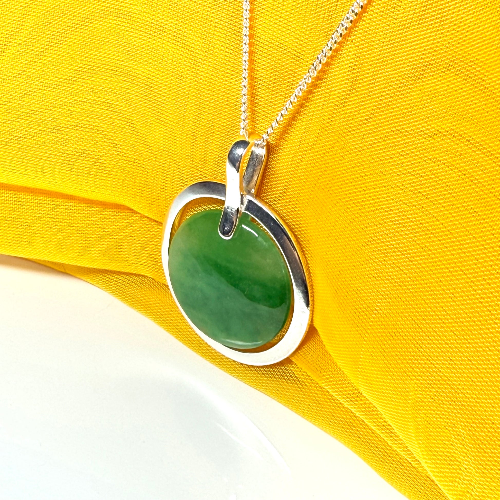 Large silver round shaped green real jade necklace pendant with a chain